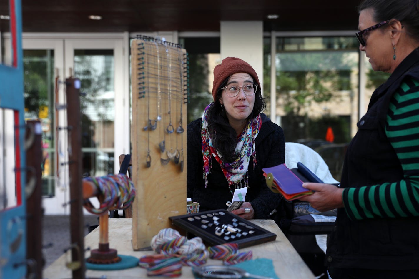 Jewelry maker Liz Parent, center, joked with a customer at her stand, Made By Liz P., in the Mill City Farmer&#x2019;s Market Saturday. NOTE: None of the requested merchants were present Saturday. Vendors sold their stylish wearables and home goods Saturday, June 24, 2017 at the Mill City Farmer&#x2019;s Market in Minneapolis. In the past couple of years, more and more modern makers are selling their stylish goods at Minnesota farmers markets. Mill City Farmer&#x2019;s Market is known for having