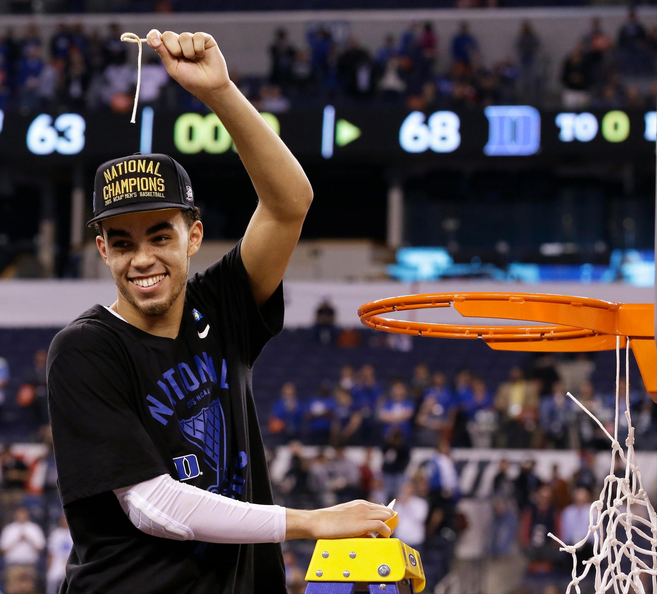 Duke's Tyus Jones cuts down the net after his team's 68-63 victory over Wisconsin in the NCAA Final Four college basketball tournament championship game Monday, April 6, 2015, in Indianapolis. (AP Photo/David J. Phillip)