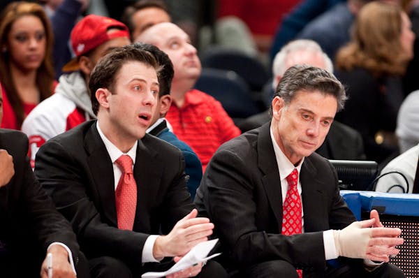 Louisville head coach Rick Pitino, right, with his son, associate coach Richard Pitino, in 2012.