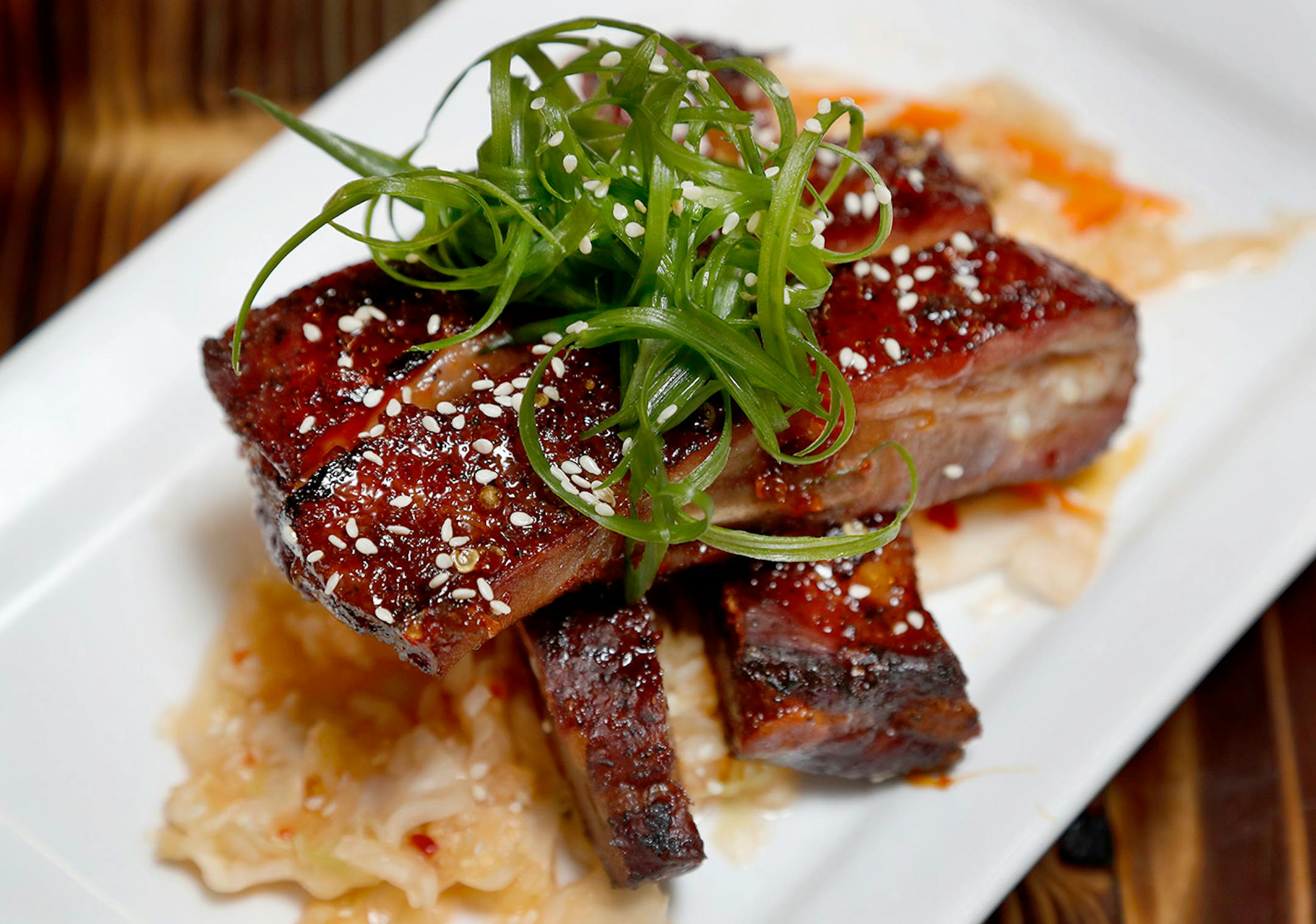 SMOKEHAUS RIBS. Dry-rubbed, maple-sambal lacquered Smokehaus back ribs served with haus-made kimchi at the Northern Waters in Duluth.