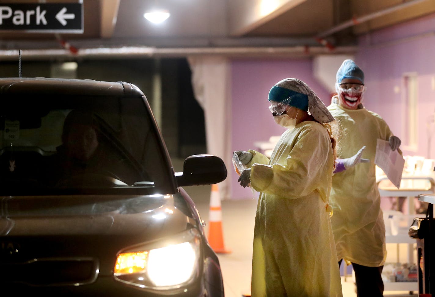 HealthPartners began its transition to indoor and winterized drive-up COVID testing sites across the Twin Cities and western Wisconsin, including in the HealthPartners corporate headquarters parking ramp where Robyn Wallin, an LPN, tested a person in the drive-up with an assist from fellow LPN Brittany Mischel on Wednesday in Bloomington.