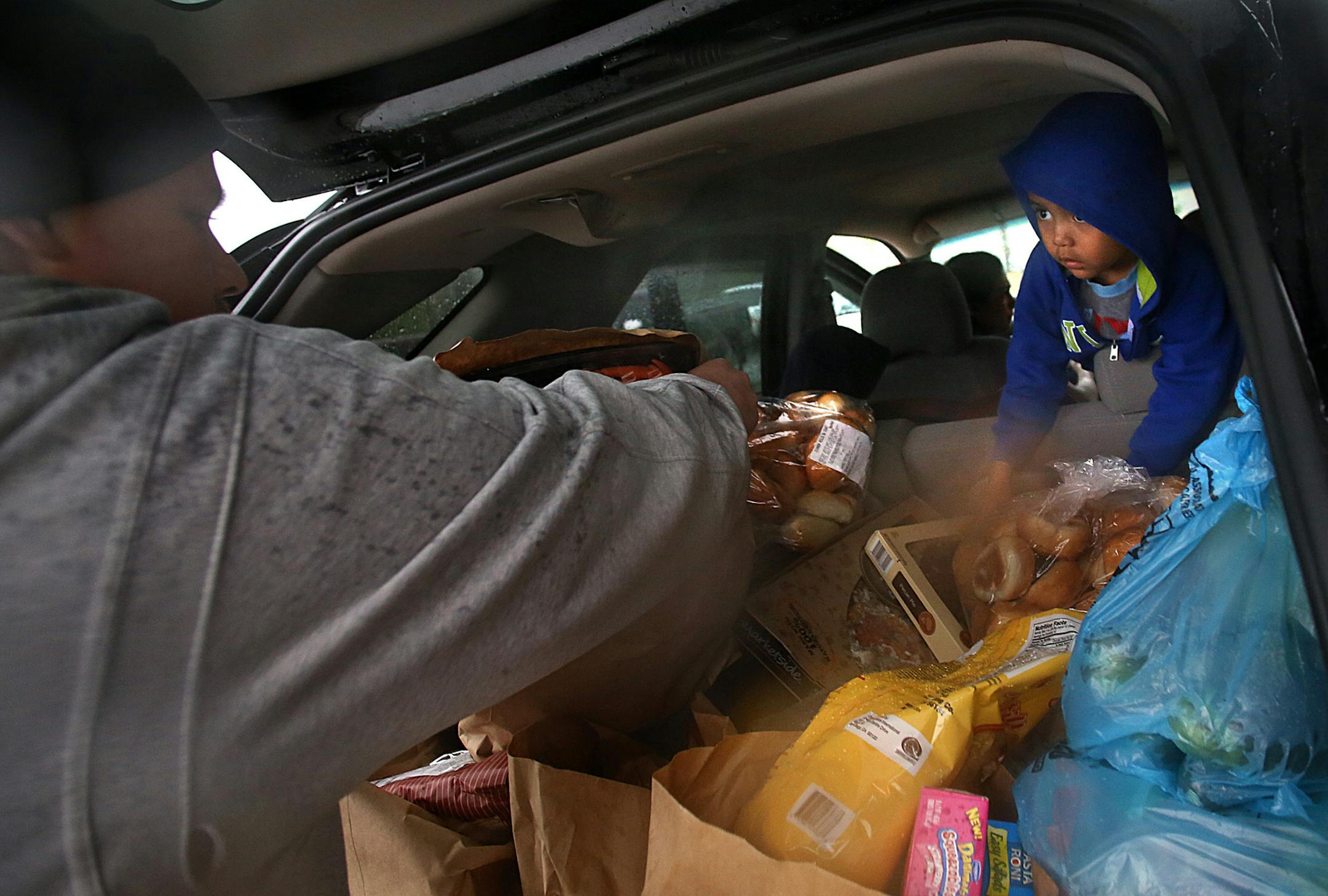 Three-year-old Leonardo Rivera accompanied his uncle, Mike Valtierra, to the food shelf. ] (JIM GEHRZ/STAR TRIBUNE) / July 23, 2011, Bloomington, MN ‚Äì BACKGROUND INFORMATION- Vineyard Community Services offers several hundred of its neighbors a variety of social services, which include a food shelf that provides food for families and seniors. The food shelf is located at the South Metro Vineyard Church.