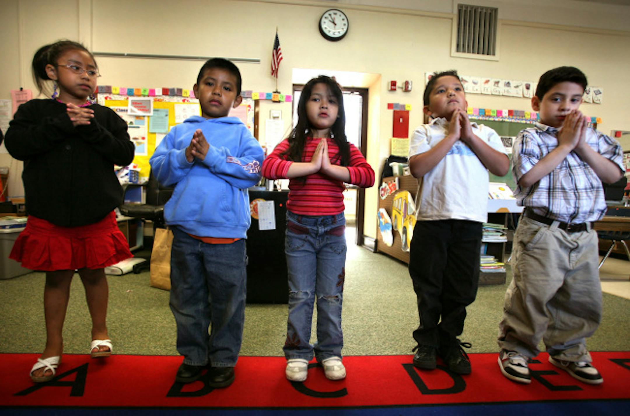 Children in Tammy Mahoney's kindergarten class at Jefferson Community School calm themselves and prepare for the day with a 10 minute yoga session. (L to R) Mayra Pacheco-Hernandez, Cesar Coyote-Aragon, Kymberlee Brown-Chy, Juan Galarza and Jason Verdugo.