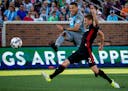 Minnesota United&#x2019;s Christian Ramirez (left) scores a goal while D.C. United&#x2019;s Taylor Kemp attempts to block during the first half on Sat