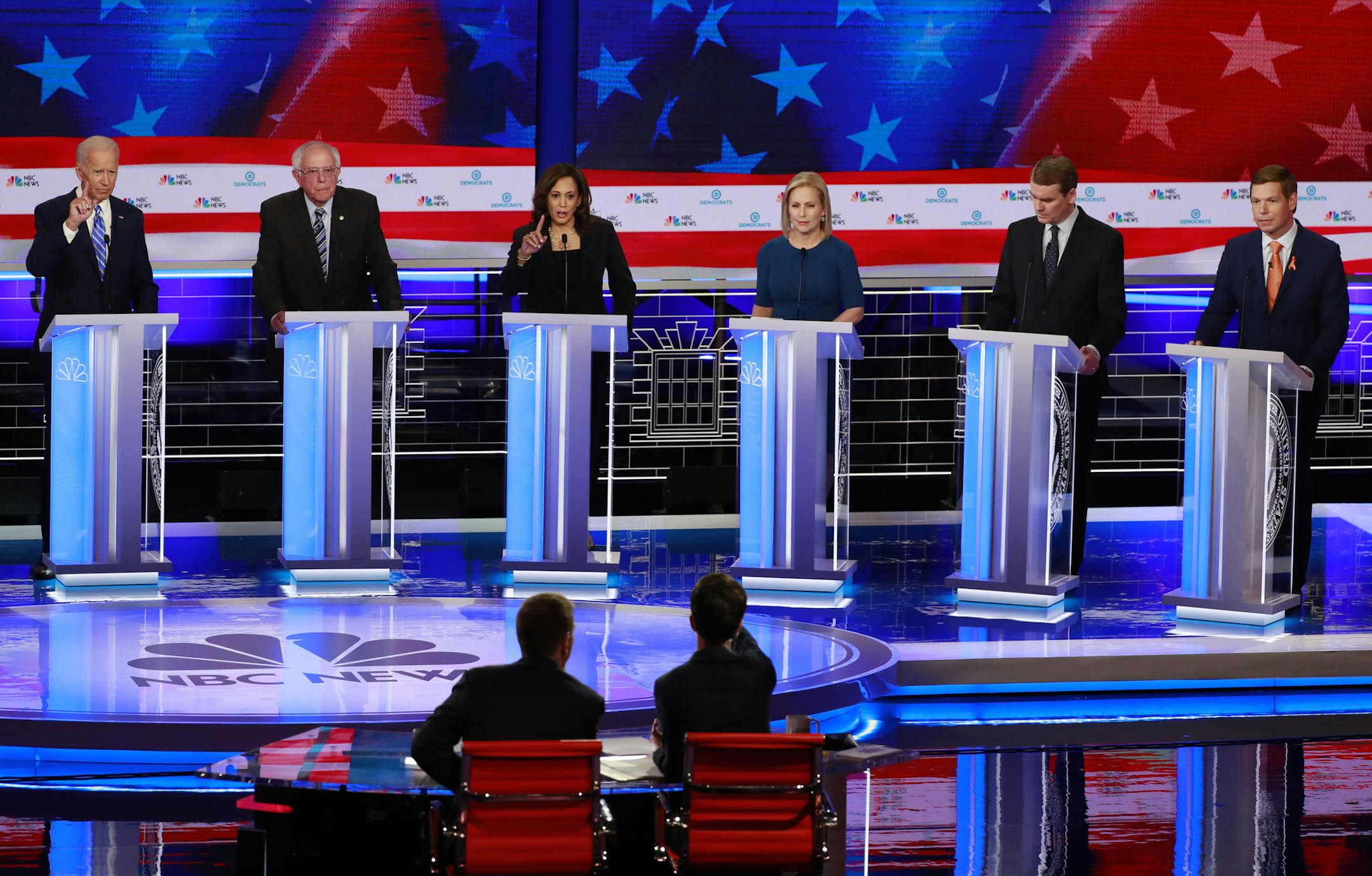 CORRECTS BENNET'S TITLE TO SENATOR, INSTEAD OF FORMER SENATOR - Democratic presidential candidates former Vice President Joe Biden, Sen. Bernie Sanders, I-Vt., Sen. Kamala Harris, D-Calif., Sen. Kirsten Gillibrand, D-N.Y., Colorado Sen. Michael Bennet, and Rep. Eric Swalwell, D-Calif., attend during the Democratic primary debate hosted by NBC News at the Adrienne Arsht Center for the Performing Arts, Thursday, June 27, 2019, in Miami. (AP Photo/Wilfredo Lee)
