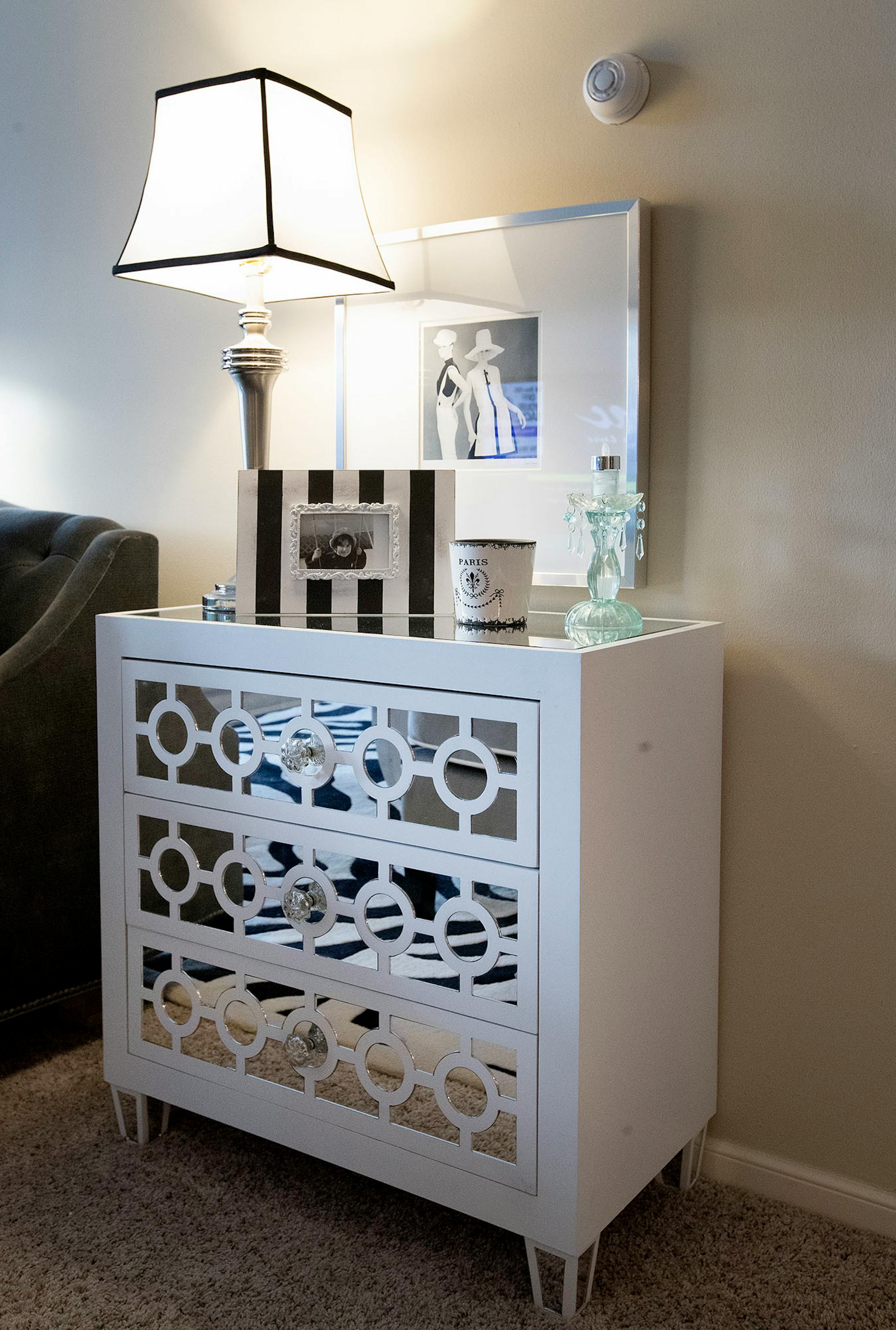 Mirrored furniture reflects light to brighten up the space.