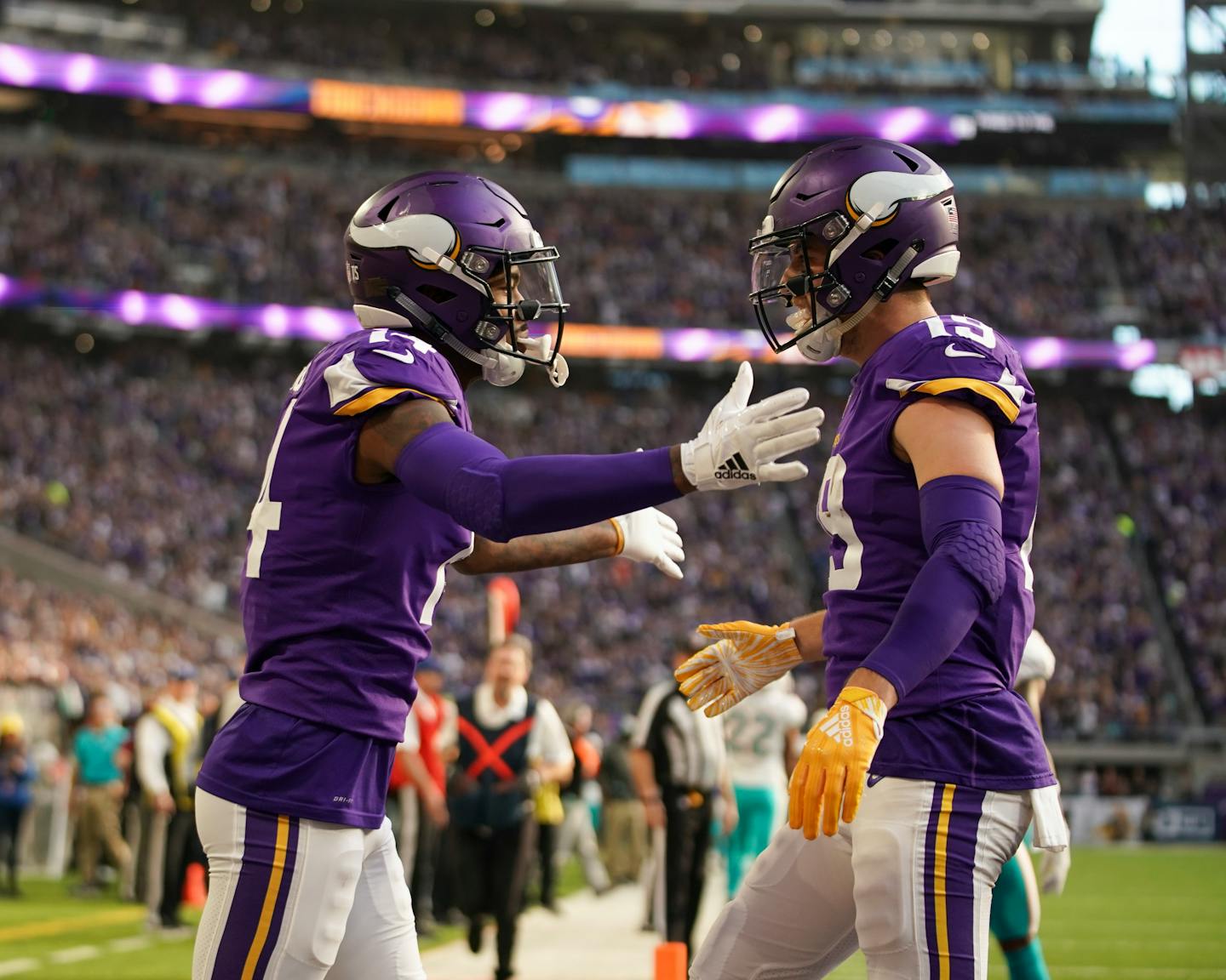 Vikings wide receiver Stefon Diggs, left, reached for Adam Thielen after catching a 13 yard touchdown pass in the first quarter.