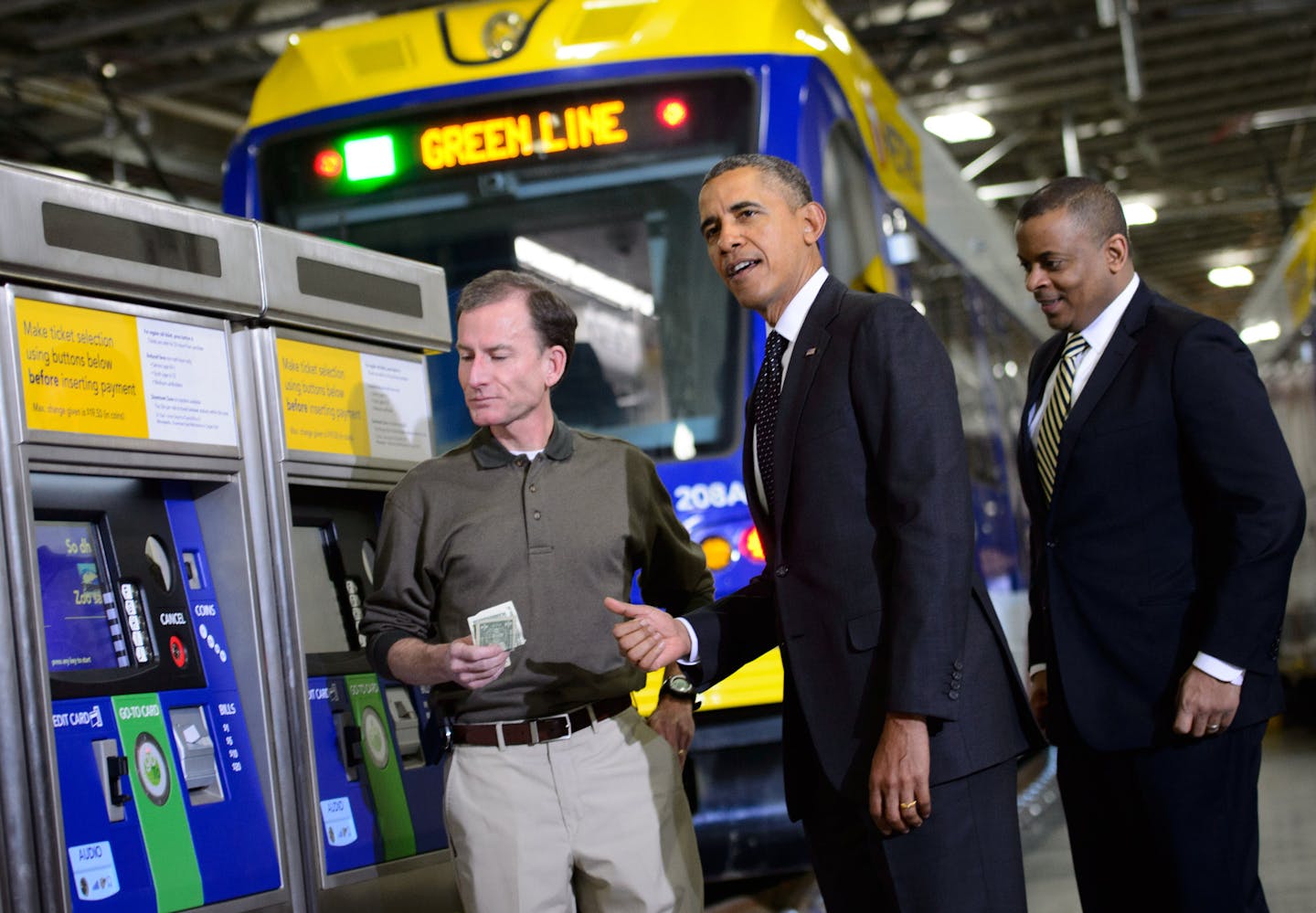 President Obama with Transportation Secretary Anthony Fox and Metro Transit program director Mark Fuhrmann. Fuhrmann bought the president a ticket and the president autographed it. President Obama traveled to St. Paul to Union Depot to unveil an jobs and infrastructure initiative. He also toured the Metro Transit Light Rail Operations and Maintenance Facility where he bought the first ticket sold from a ticket station there. Wednesday, February 26, 2014 ] GLEN STUBBE * gstubbe@startribune.com