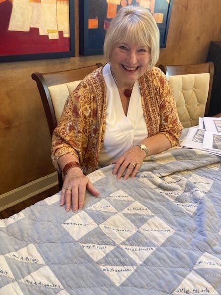 Pamela Peterman displays a 1920s signature quilt she’s researched and traced back to Messiah Lutheran Church in Minneapolis. 