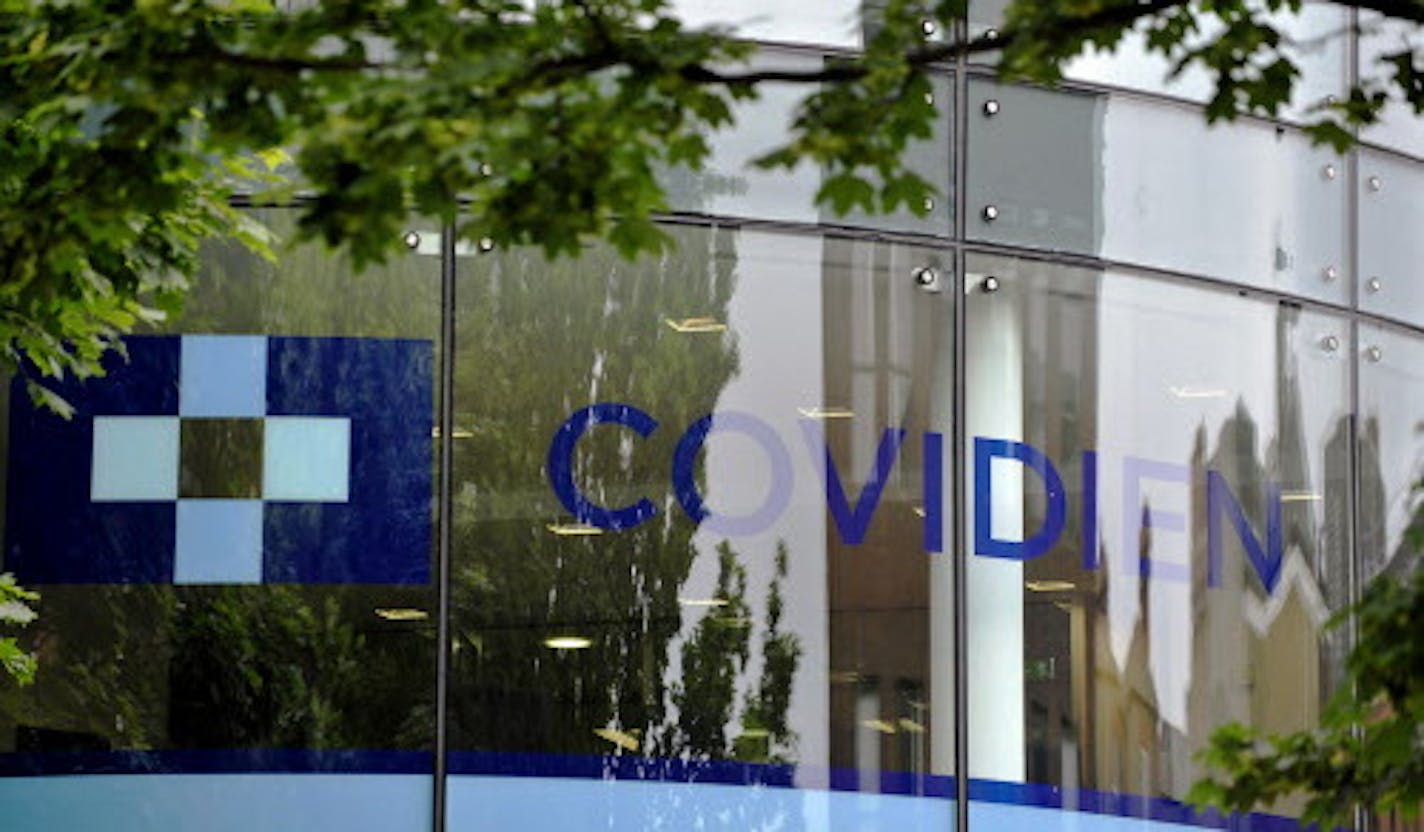 A Covidien logo sits on the glass windows of medical device manufacturer Covidien Plc's head office in Dublin, Ireland, on Monday, June 16, 2014. Medtronic Inc., the second-largest maker of medical devices, agreed to buy Covidien for $42.9 billion in cash and stock as it transforms into a broader-based company bolstered by new tax advantages. Photographer: Aidan Crawley/Bloomberg ORG XMIT: 498097627