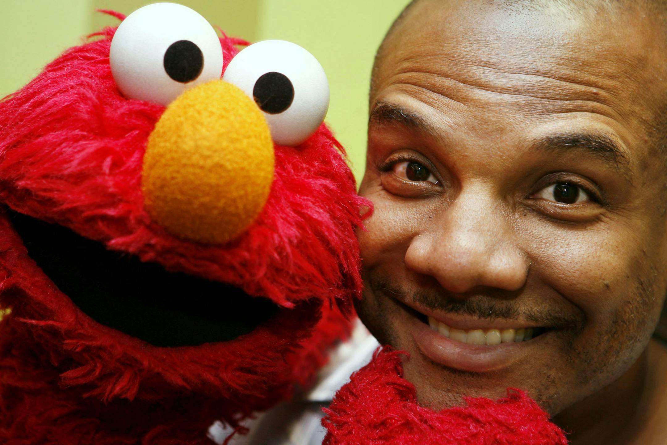 FILE - This Aug 16, 2006 file photo shows Kevin Clash, who was the voice and movements behind Sesame Street's Elmo, posing for a picture with Elmo in New York. Three lawsuits brought by men who said Clash sexually abused them when they were underage were tossed out by a federal judge who said in a decision published Monday, July 1, 2013, that the men waited too long to sue. (AP Photo/Seth Wenig, File)