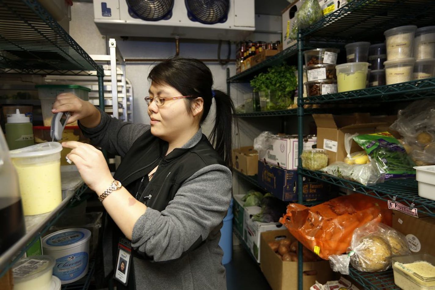 Minneapolis health inspector Mai P. Yang checked the temperature inside of the walk in cooler at the Sassy Spoon in Minneapolis.