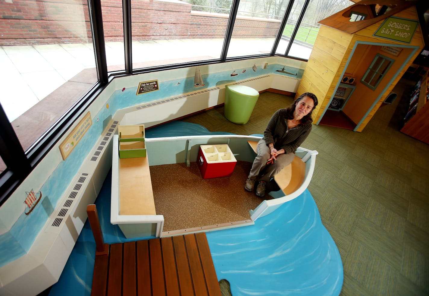 Julie Prairie, a mural artist for the Children's Museum created this wall painting and boat scene in Wescott Library in Eagan. ] JOELKOYAMA&#x201a;&#xc4;&#xa2;jkoyama@startribune Minneapolis, MN on May 8, 2014. Julie Prairie, a mural artist for the Children's Museum will do some more painting in Wescott Library in Eagan.