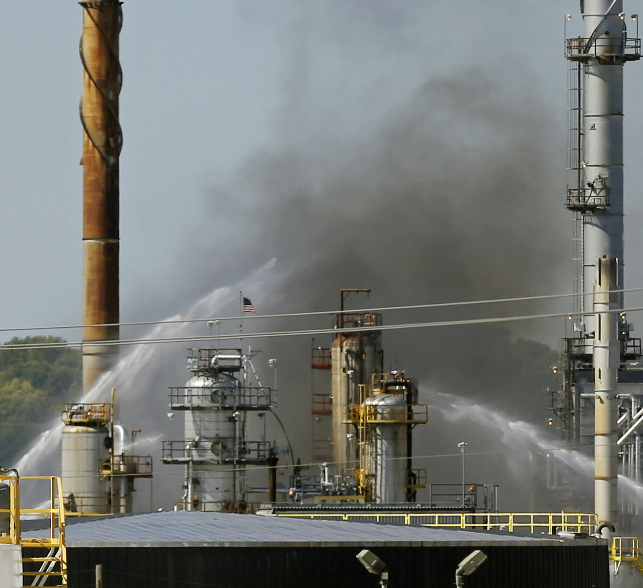 At the Norther Tier Energy refinery in St. Paul Park, several crews fought a fire that began in the late morning and sent up smoke that was visible for miles in the surrounding area .]richard tsong-taatarii/rtsong-taataarii@startribune.com