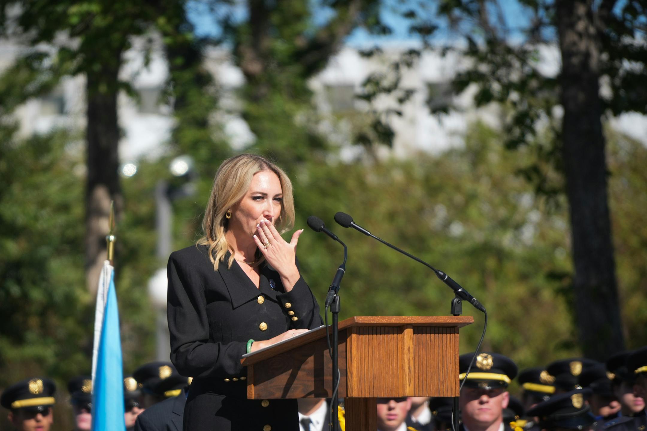 Minnesota Medal of Honor Memorial Board Chair Tiffany Kovaleski blows a kiss to her family in the crowd while speaking Thursday.