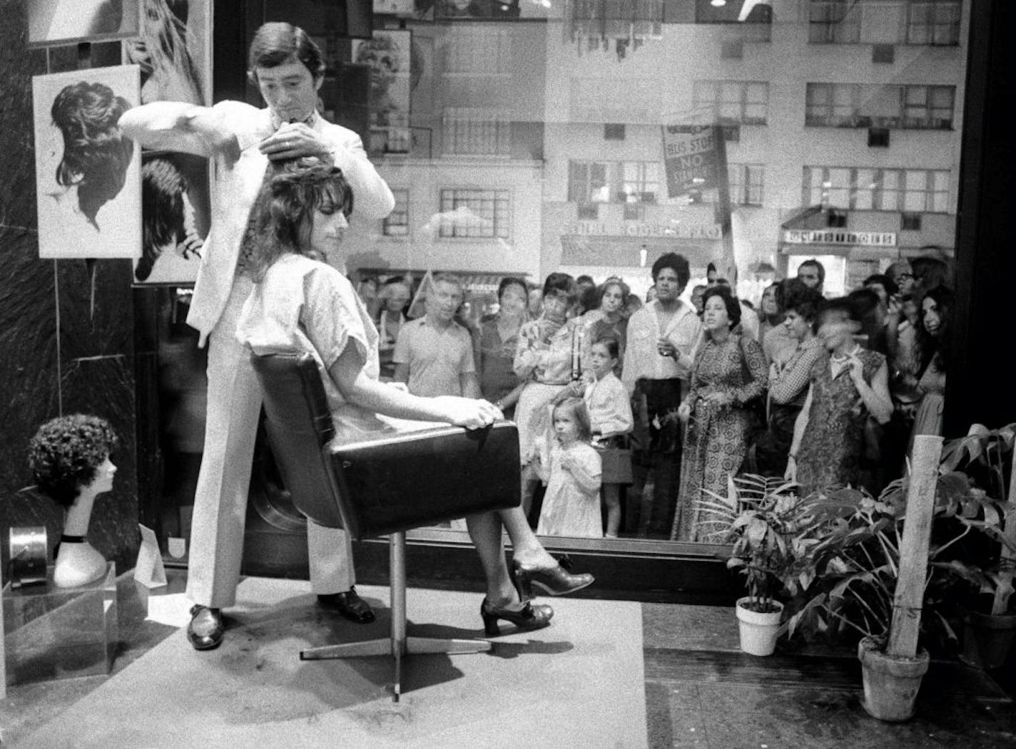 FILE -- Vidal Sassoon cuts hair in the window of his salon in New York, on Sept. 22, 1970. Sassoon, whose wash-and-wear cuts came into vogue in the 1960s, died at his home in Los Angeles on Wednesday, May 9, 2012. He was 84.