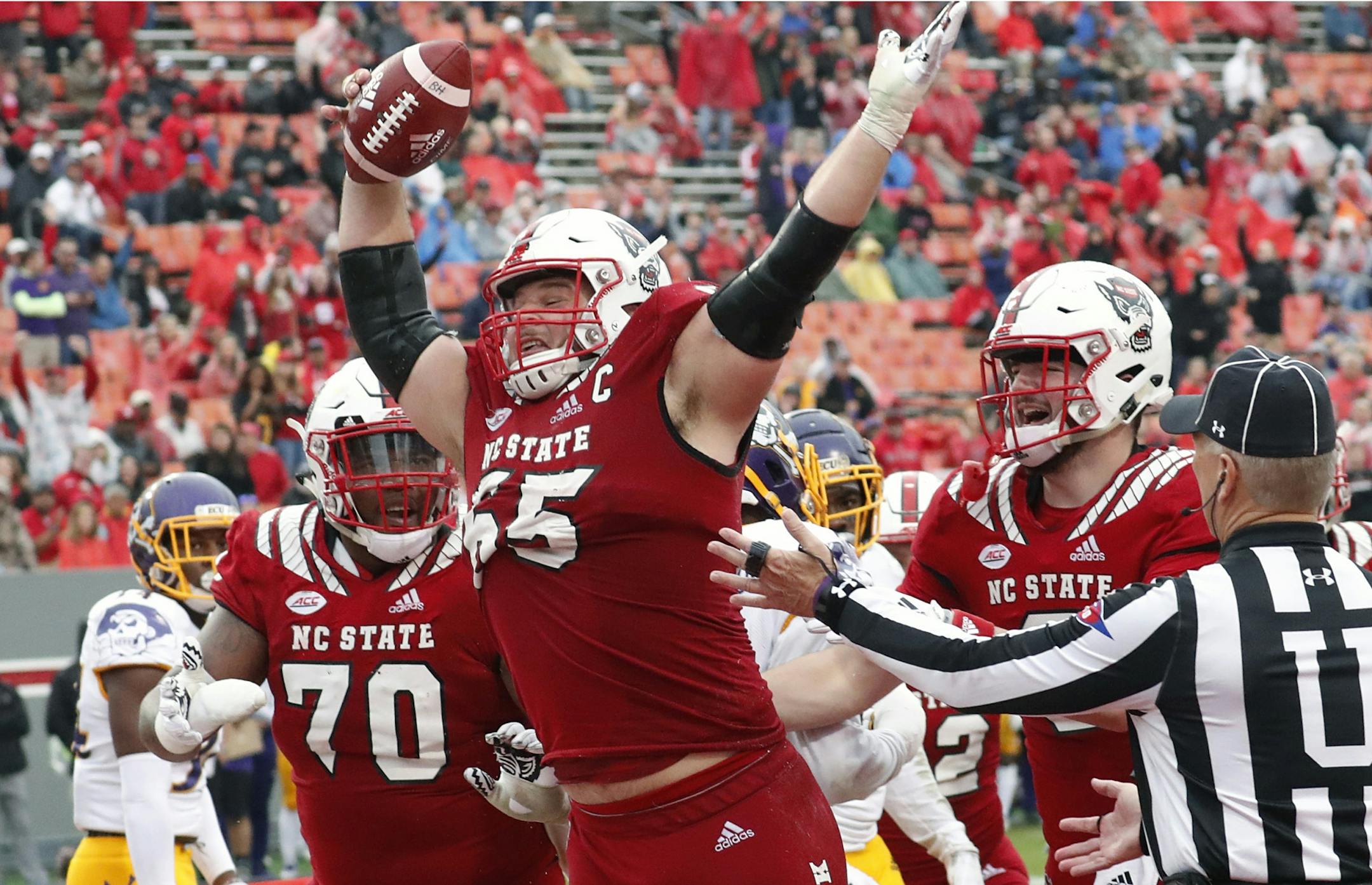 FILE - In this Dec. 1, 2018, file photo, North Carolina State's Garrett Bradbury (65) celebrates after he scored a touchdown during the second half of NCAA college football game, in Raleigh, N.C.Bradbury is a possible pick in the 2019 NFL Draft.