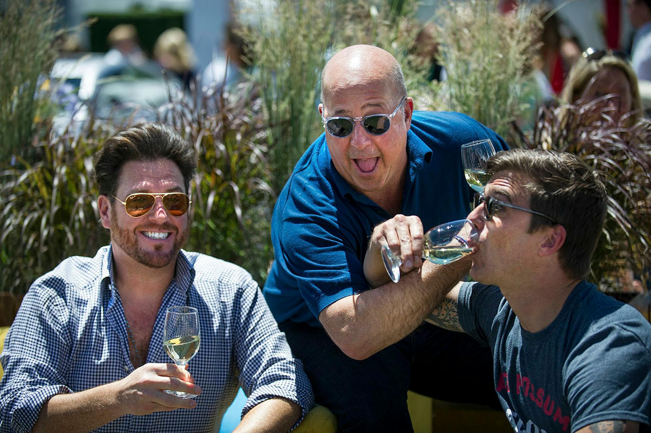 Top chefs, Scott Conant, left, Andrew Zimmern, center, and Hugh Acheson share a laugh between the tents at the first Grand Tasting of this year's Food and Wine Classic, Friday, June 16, 2017 in Aspen, Colo.