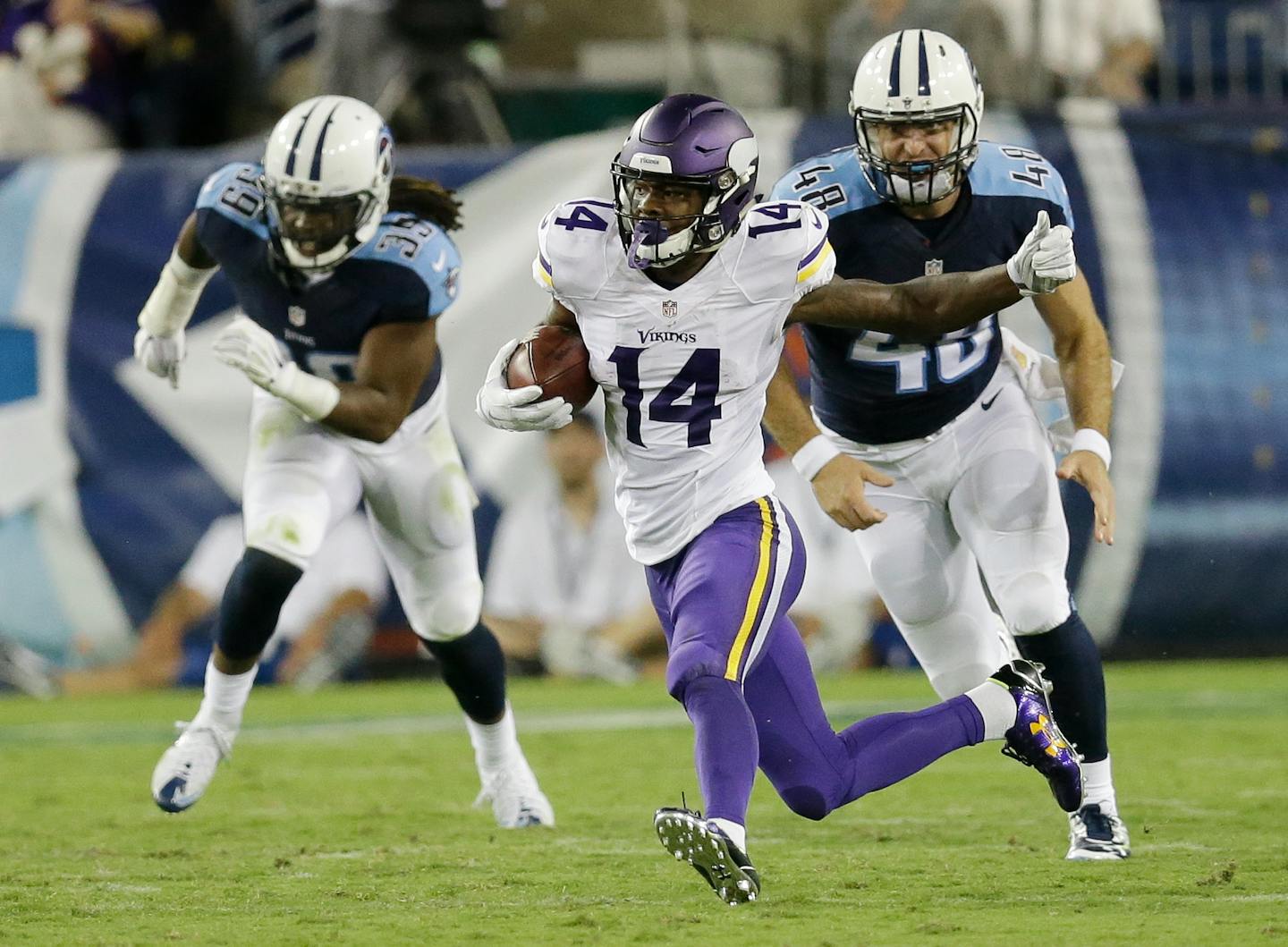 Minnesota Vikings' Stefon Diggs (14) gets past Tennessee Titans defenders Daimion Stafford (39) and Beau Brinkley (48) in the second half of a preseason NFL football game Thursday, Sept. 3, 2015, in Nashville, Tenn. (AP Photo/James Kenney)