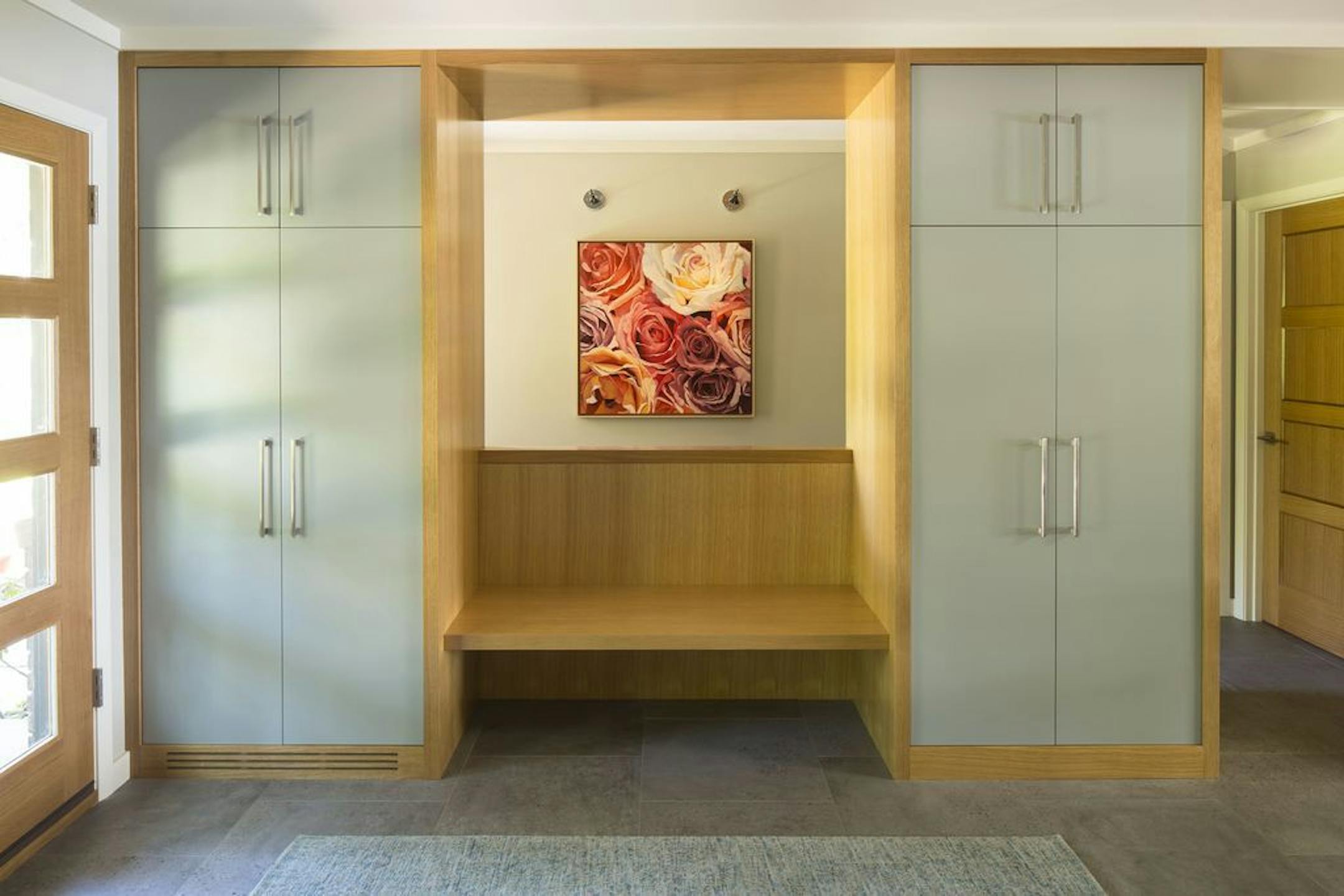 Closets flank a built-in bench in the redesigned entry.