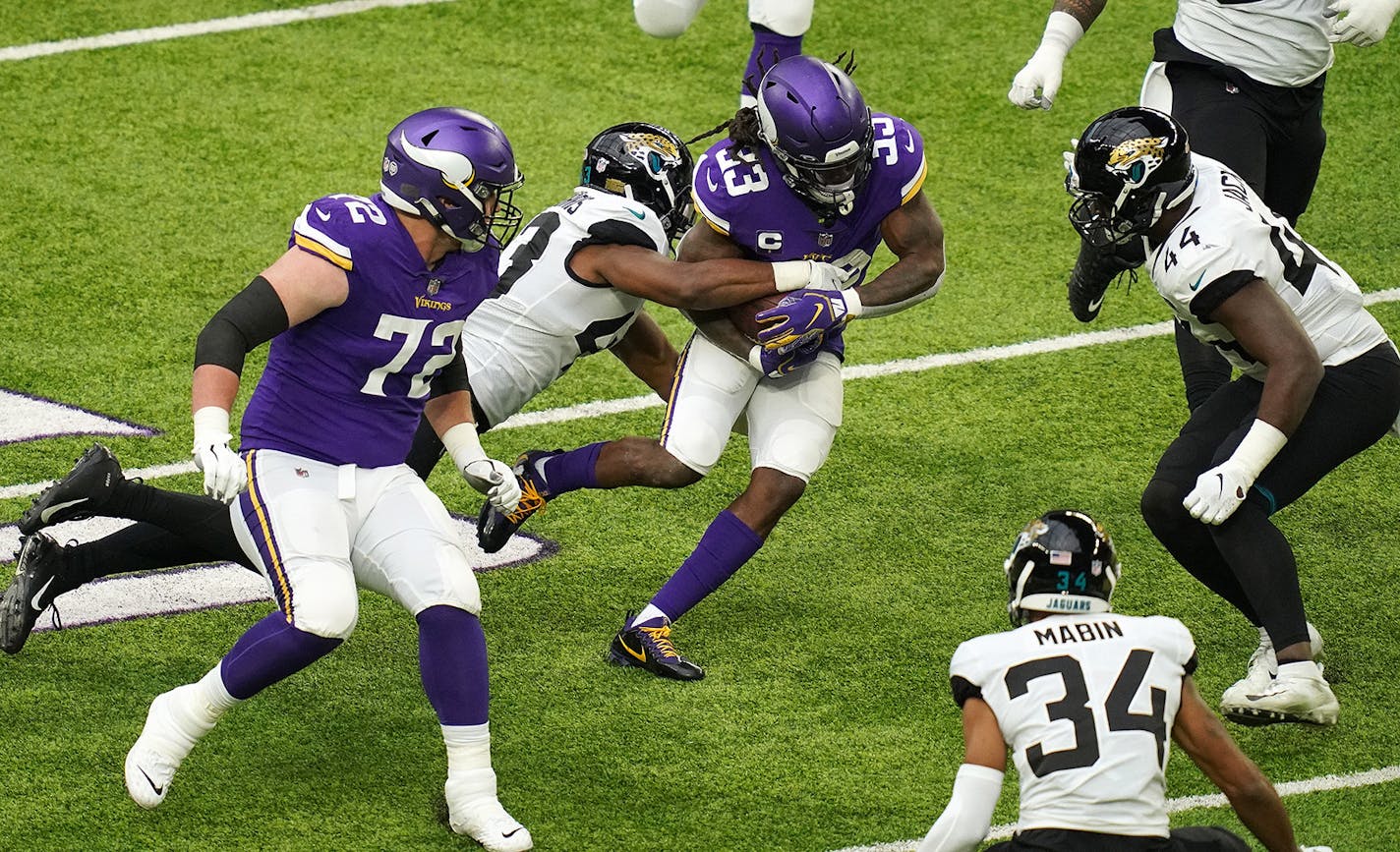 Minnesota Vikings running back Dalvin Cook (33) rushed the ball as Jacksonville Jaguars linebacker Joe Giles-Harris (43) made the tackle in the second quarter.