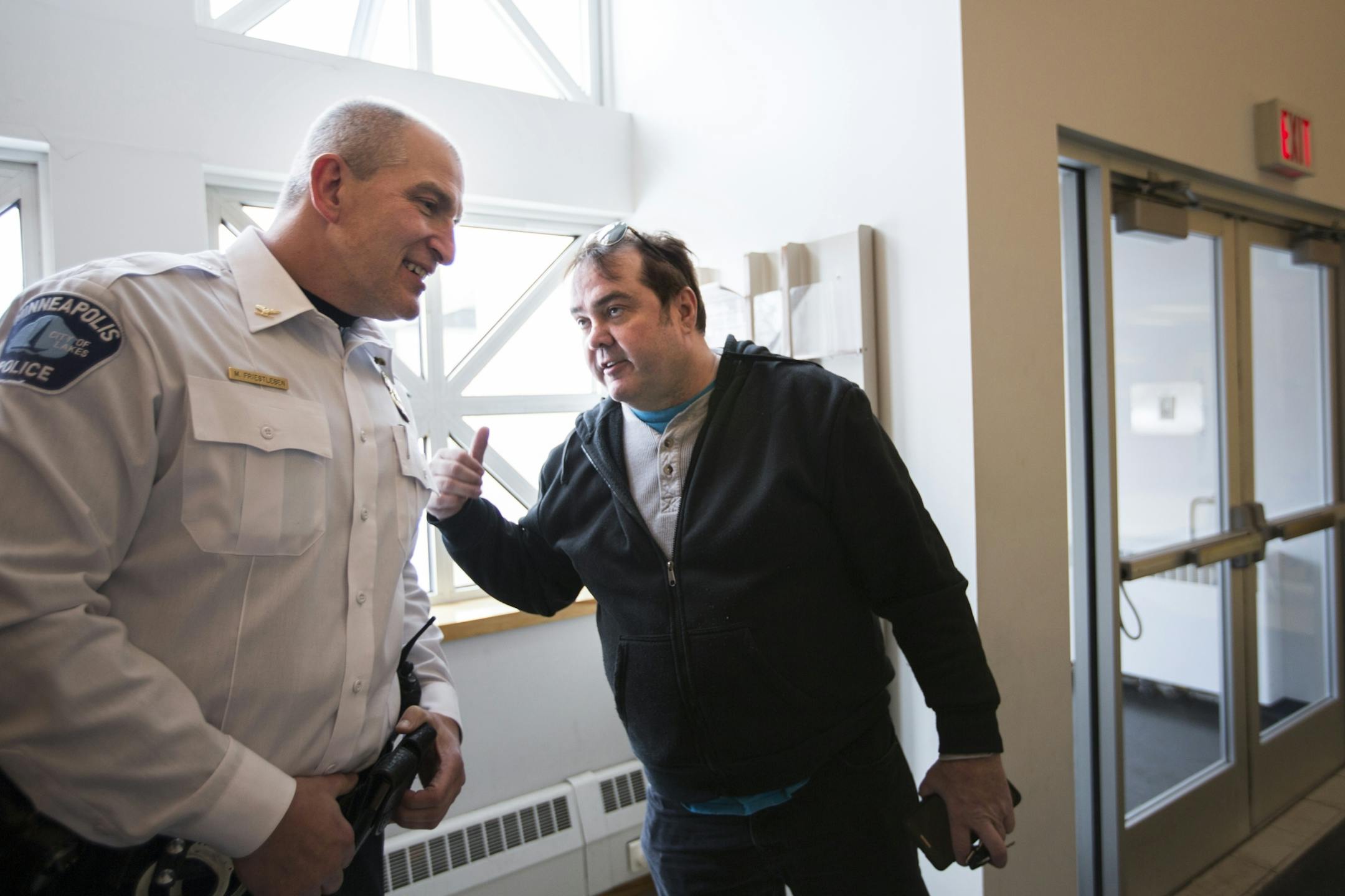 Inspector Mike Friestleben of Minneapolis Police Department's Fourth Precinct talks to north Minneapolis resident Phil Murphy in the reception area of the Fourth Precinct Police Station in north Minneapolis on Wednesday, January 27, 2016.