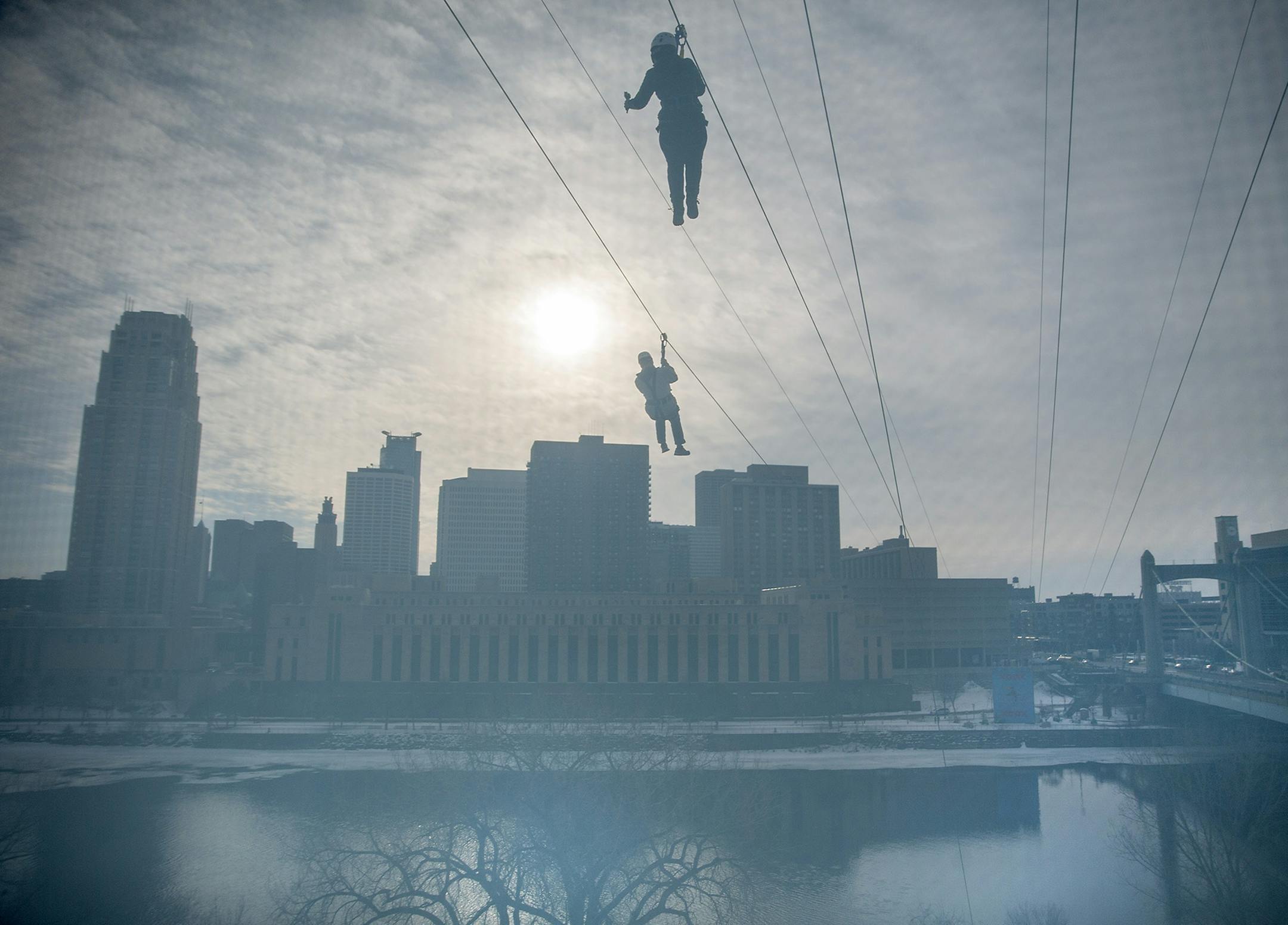 With the skyline for a view people made their way across the Mississippi River via zip line, Friday, January 26, 2018 in Minneapolis, MN. ] ELIZABETH FLORES ï liz.flores@startribune.com