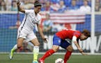 FILE - In this May 30, 2015, file photo, United States midfielder Carli Lloyd, left, battles for the ball with South Korea forward Jung Seolbin during