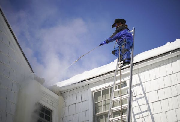 Jake Weber with Ice Dam Guys was steaming off a large ice dam from the gutter of an Edina home on Thursday afternoon.