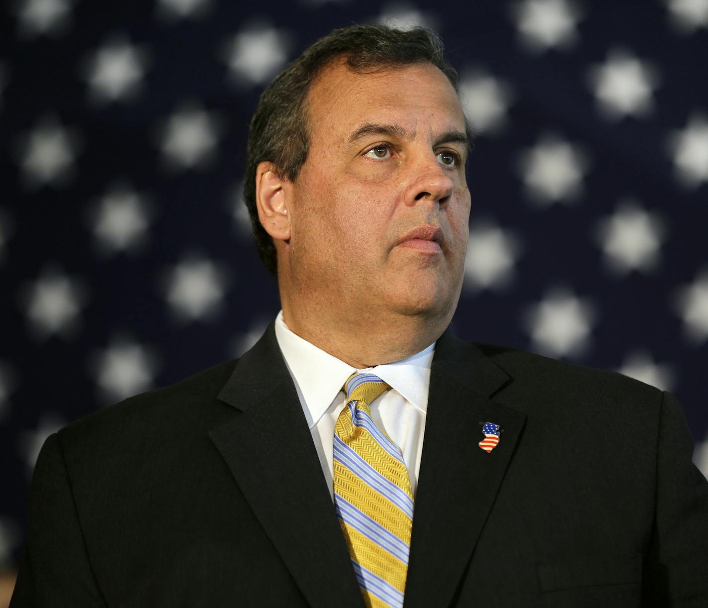 New Jersey Gov. Chris Christie listens to a question as he addresses a gathering at the Chabad House at Rutgers University Tuesday, Aug. 25, 2015, in New Brunswick, N.J. Christie urged Democratic Sen. Cory Booker and the state's congressional delegation to oppose the Iran deal, which is aimed at curbing Iran's nuclear weapons development.(AP Photo/Mel Evans)