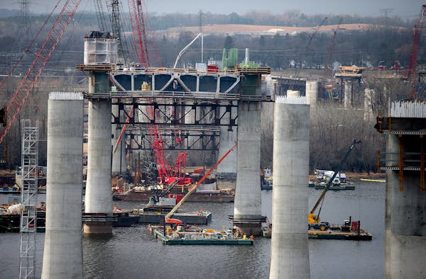 Construction crew worked high above the St. Croix on the bridge that will connect Wisconsin and Minnesota, Friday, April 10, 2015 near Stillwater, MN.