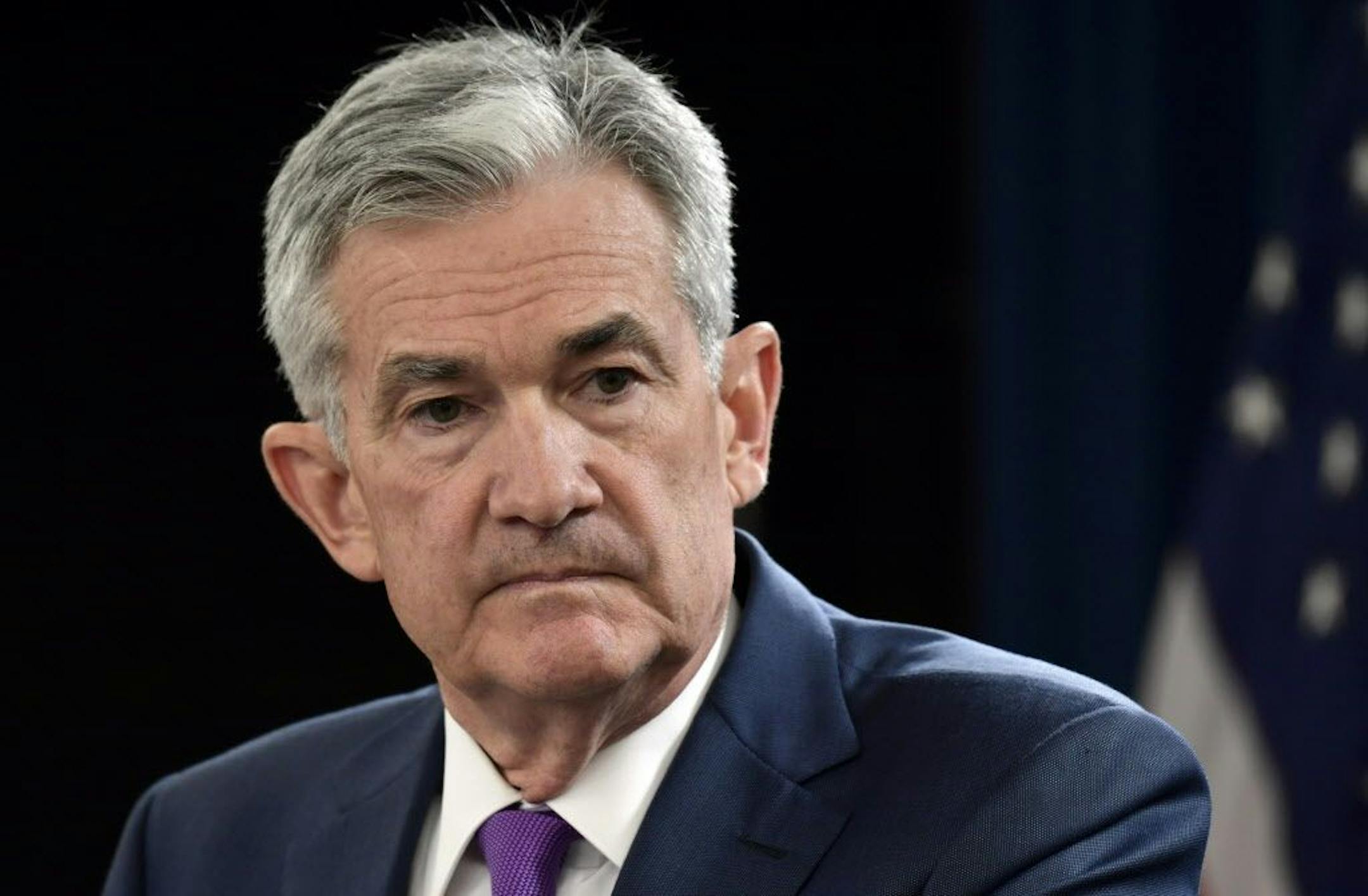 FILE- In this Sept. 26, 2018, file photo Federal Reserve Chairman Jerome Powell listens to a question during a news conference in Washington. The Federal Reserve is signaling potentially vulnerable spots in the financial system, citing U.S. businesses' debt at the highest levels in more than two decades and risky debt growing. The Fed's report issued Wednesday, Nov. 28, was its first assessing the stability of the U.S. financial system.