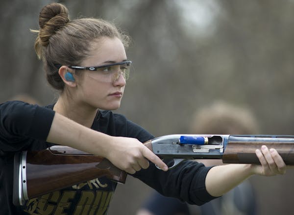 Kerri Mueller, a junior at Wayzata and member of the varsity team, looks down range after shooting a clay pigeon during practice on Thursday afternoon