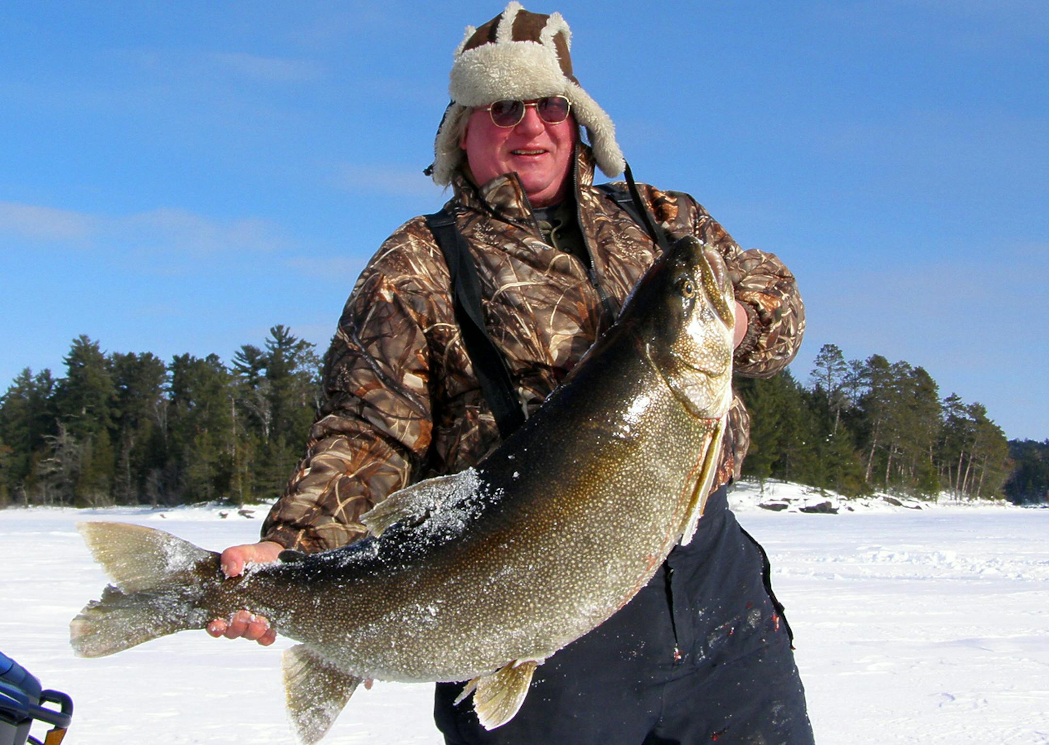 Rob Scott of Crane Lake, Minn., has pleaded guilty and paid nearly $500 for violating Canadian fishing laws when he kept this potential world record lake trout.