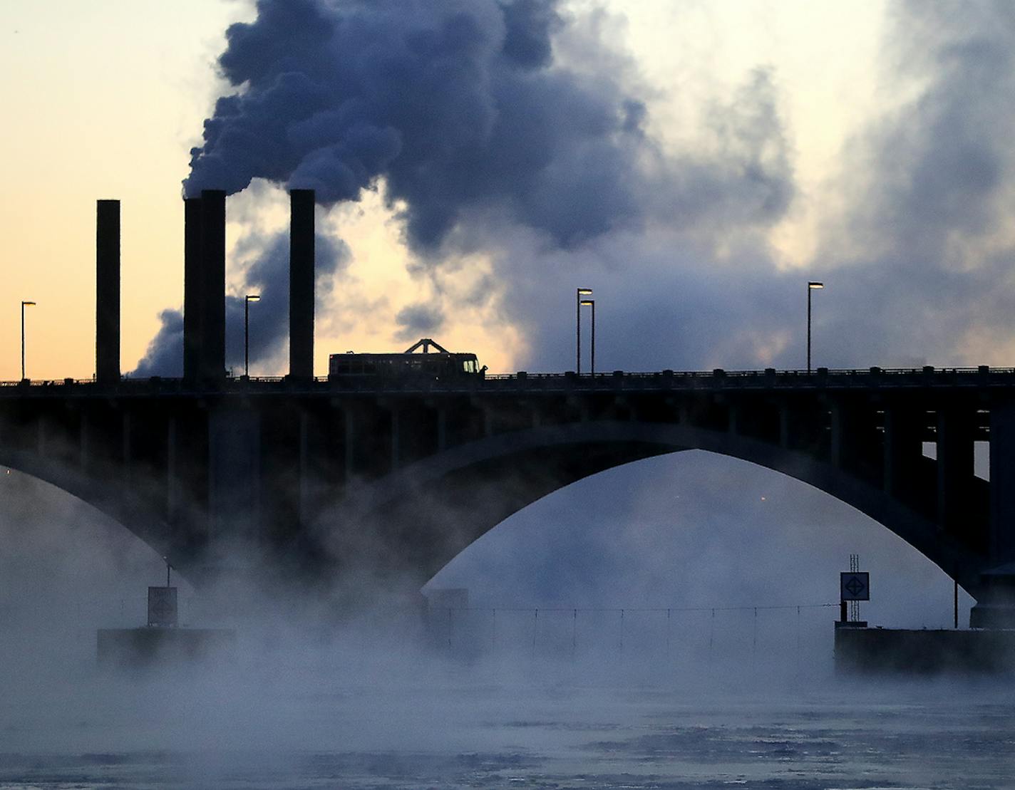 Seen from West River Parkway in downtown Minneapolis, water vapor rises from the Mississippi River near the 3rd Avenue Bridge in January.