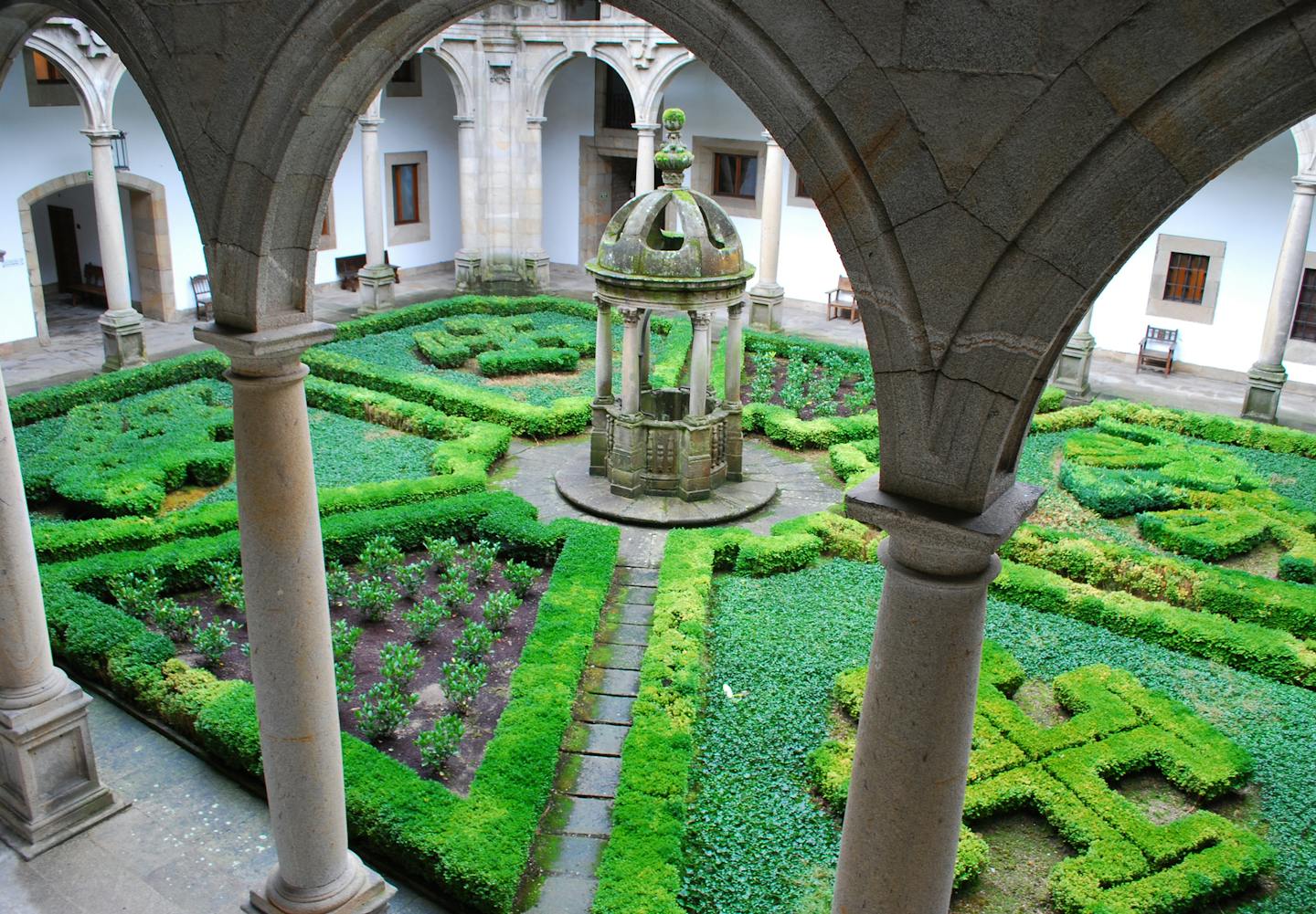 Parador de Santiago de Compostela, once a royal hospital for pilgrims, has four arcaded cloisters; in the San Mateo cloister (above), crosses nod to that past.