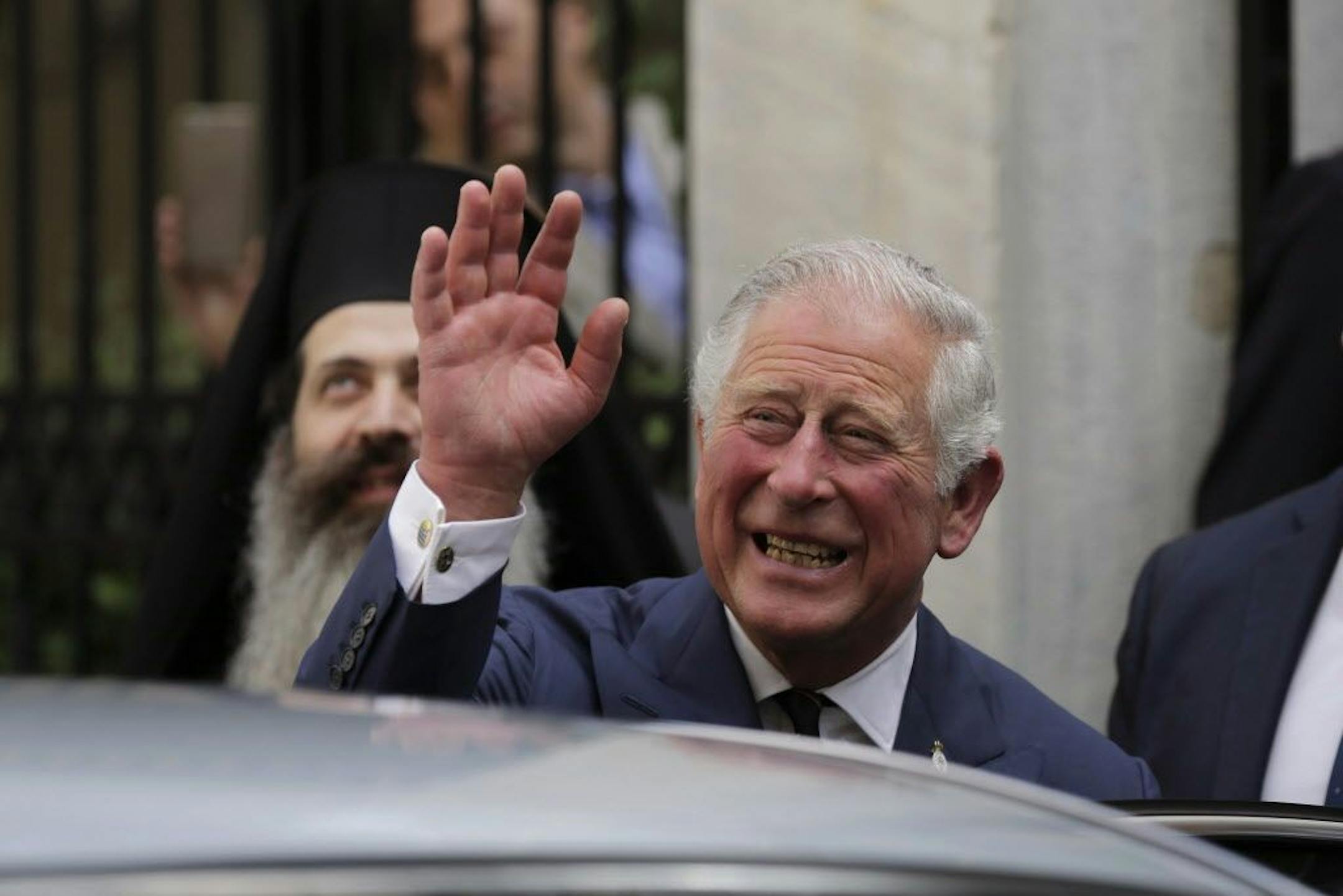 FILE - In this Thursday, May 10, 2018 file photo, Britain's Prince Charles, waves as he leaves a meeting with the head of Greece's Orthodox Church Archbishop Ieronymos, in Athens. Kensington Palace announced on Friday, May 18, 2018 Prince Charles will walk Meghan Markle down the aisle in her wedding to Prince Harry.