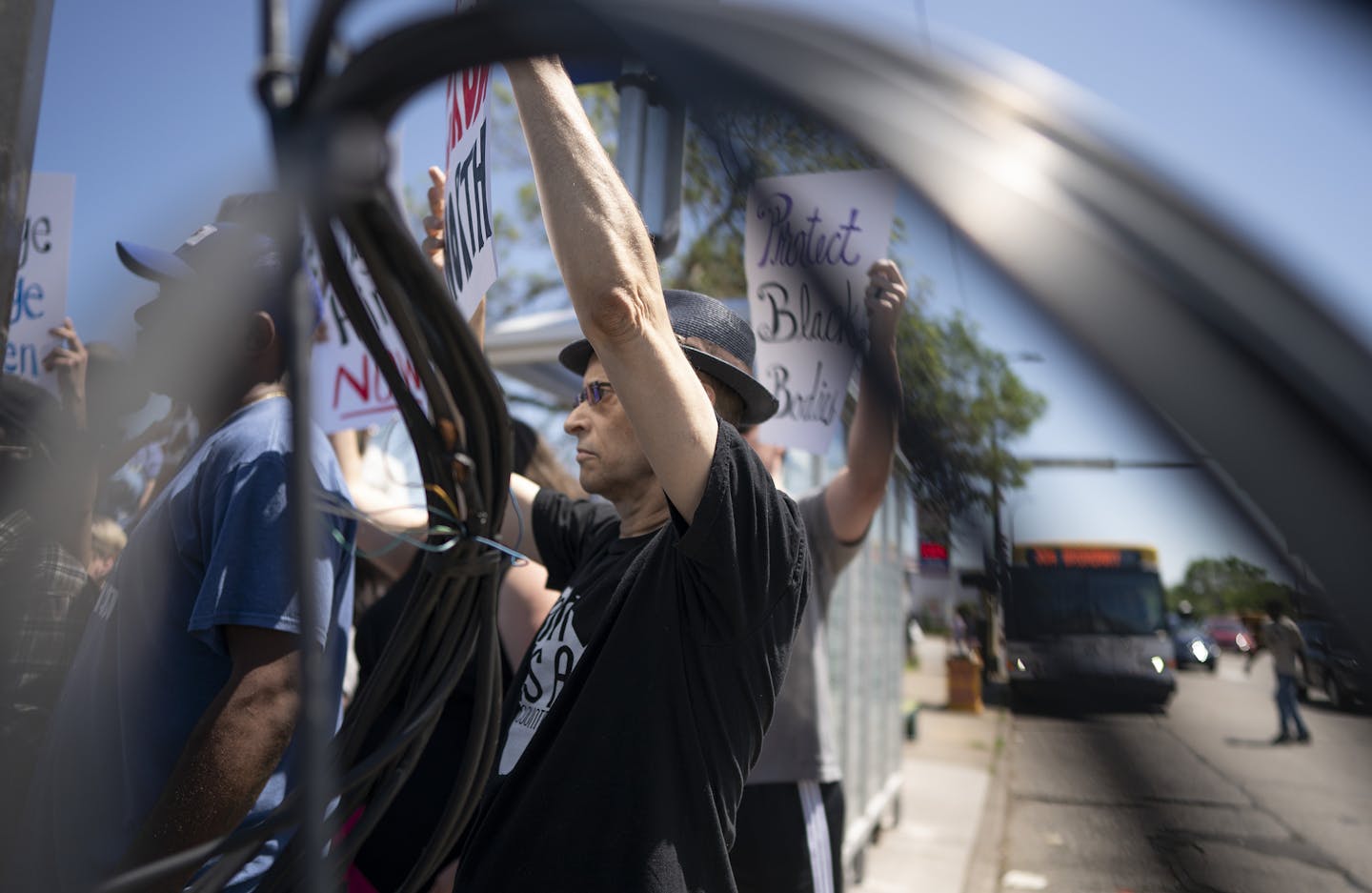 Keith McCarron held a protest sign between the twisted wires left over from scene were George Jensen 83, of Champlin driver of a van that plowed in to a bus shelter on Broadway Avenue N, near Lyndale Avenue Thursday July,11 2019 in Minneapolis, MN.] Jerry Holt &#x2022; Jerry.holt@startribune.com