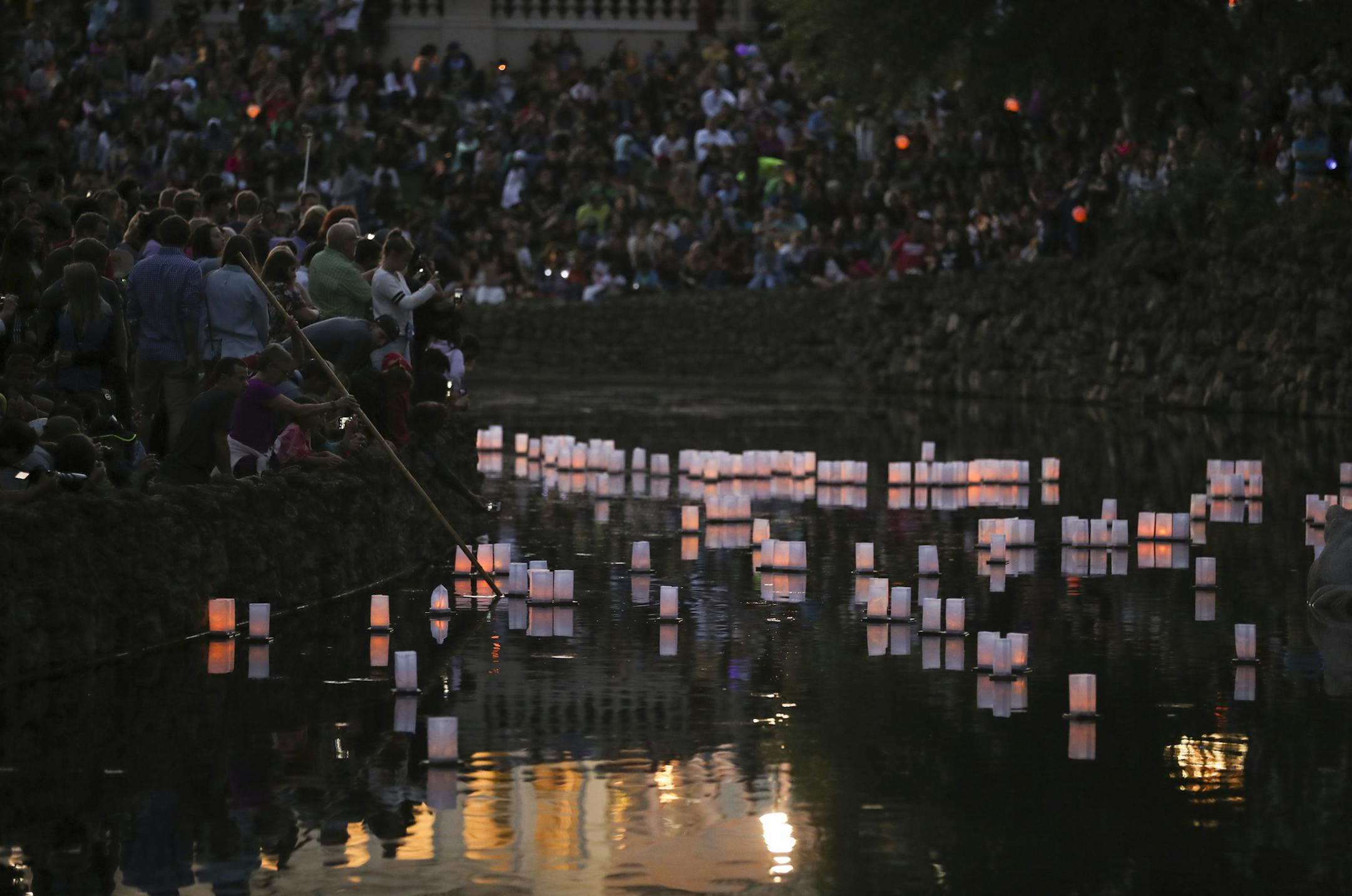 Lanterns floated in the Frog Pond near the Marjorie McNeely Conservatory in Como Park at dusk Sunday night as part of Como's Japanese Lantern Lighting Festival.