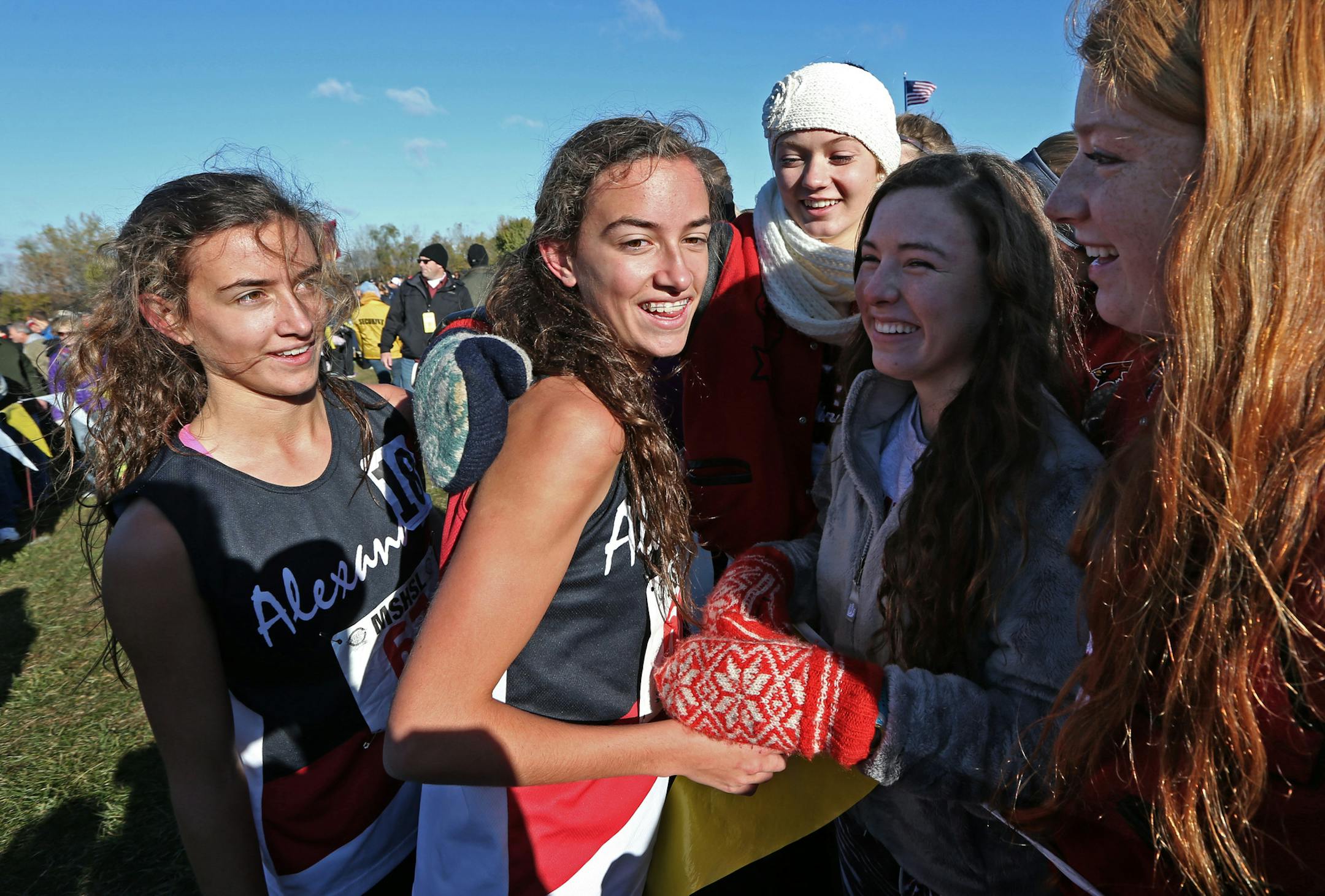 MSHSL State Cross Country Meet, Northfield MN., 11/2/13, Class AA Girls, (left to right) Megan Hasz (who placed 2nd) and sister Bethany Hasz, who placed first in the Girls Class AA cross country race celebrated with friends near the finish line.] Bruce Bisping/Star Tribune bbisping@startribune Megan Hasz, Bethany Hasz/roster. ORG XMIT: MIN1311021545076281