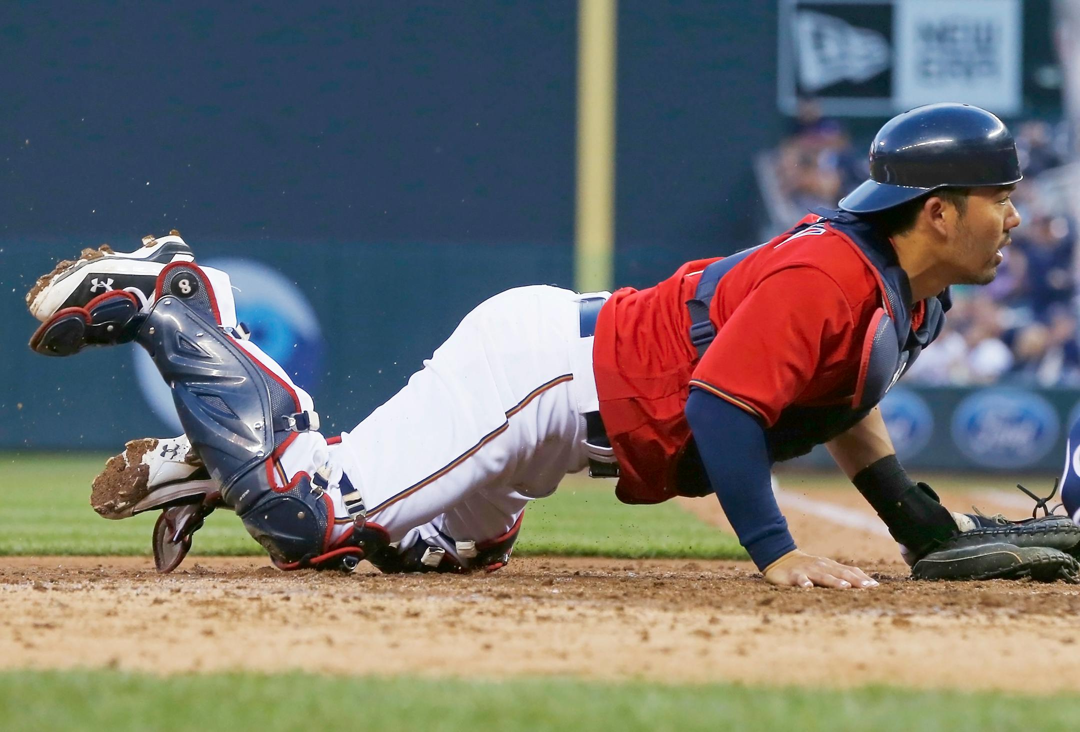 Minnesota Twins catcher Kurt Suzuki looks on as Tampa Bay Rays' Steven Souza Jr. beats Suzuki's tag to score on a sacrifice fly by Mike Mahtook, evening the score in the fifth inning of a baseball game Friday, June 3, 2016, in Minneapolis. (AP Photo/Jim Mone)