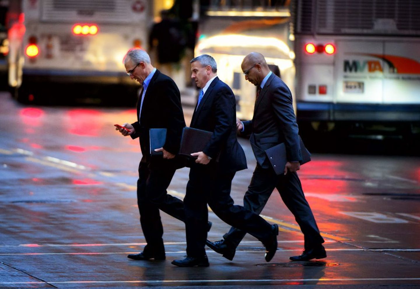 Pedestrians use their mobile devices during the evening rush hour near the Nicollet Mall light rail station at 5th St. and Marquette Ave.