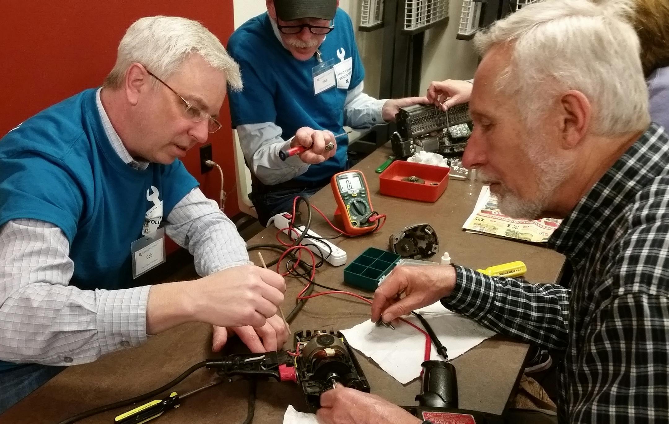 A fixer helps repair a drill.