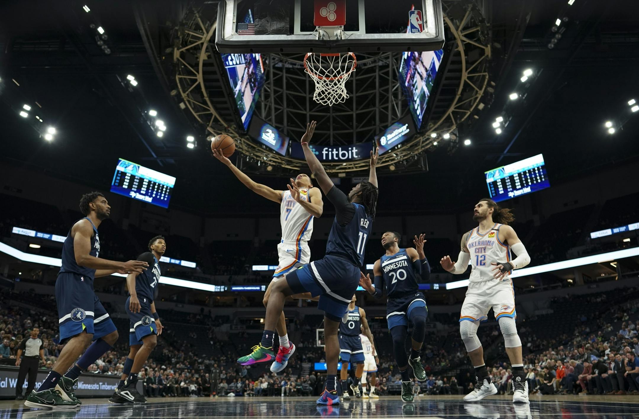 Oklahoma City Thunder forward Darius Bazley (7) shot while Minnesota Timberwolves center Naz Reid (11) defended in the first half.