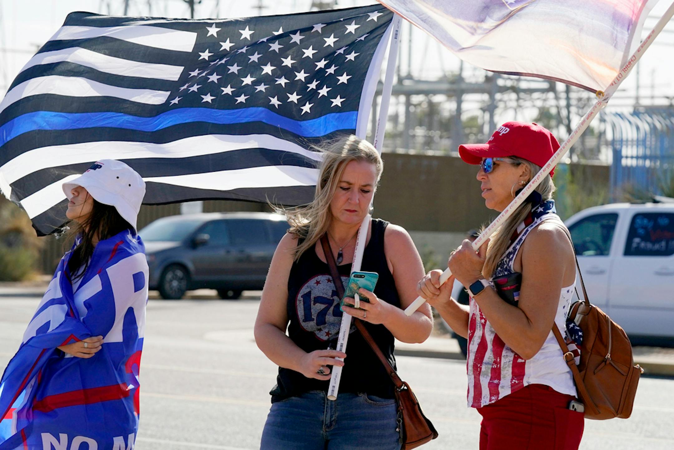 Supporters of President Donald Trump rally outside the Maricopa County Recorder's Office Saturday, Nov. 7, 2020, in Phoenix.