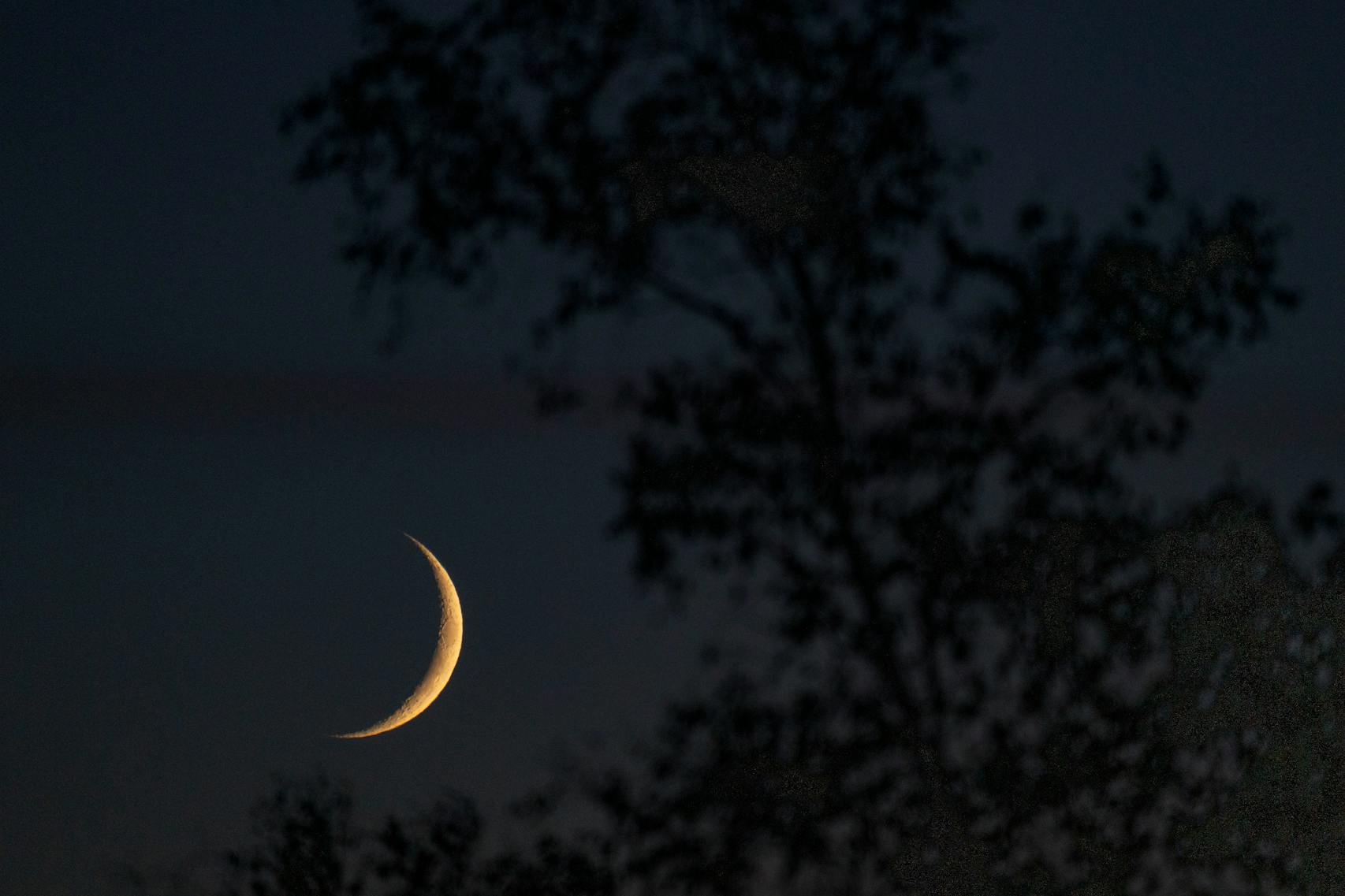 A fall waxing crescent moon moves toward the horizon in Grand Portage, Minn.