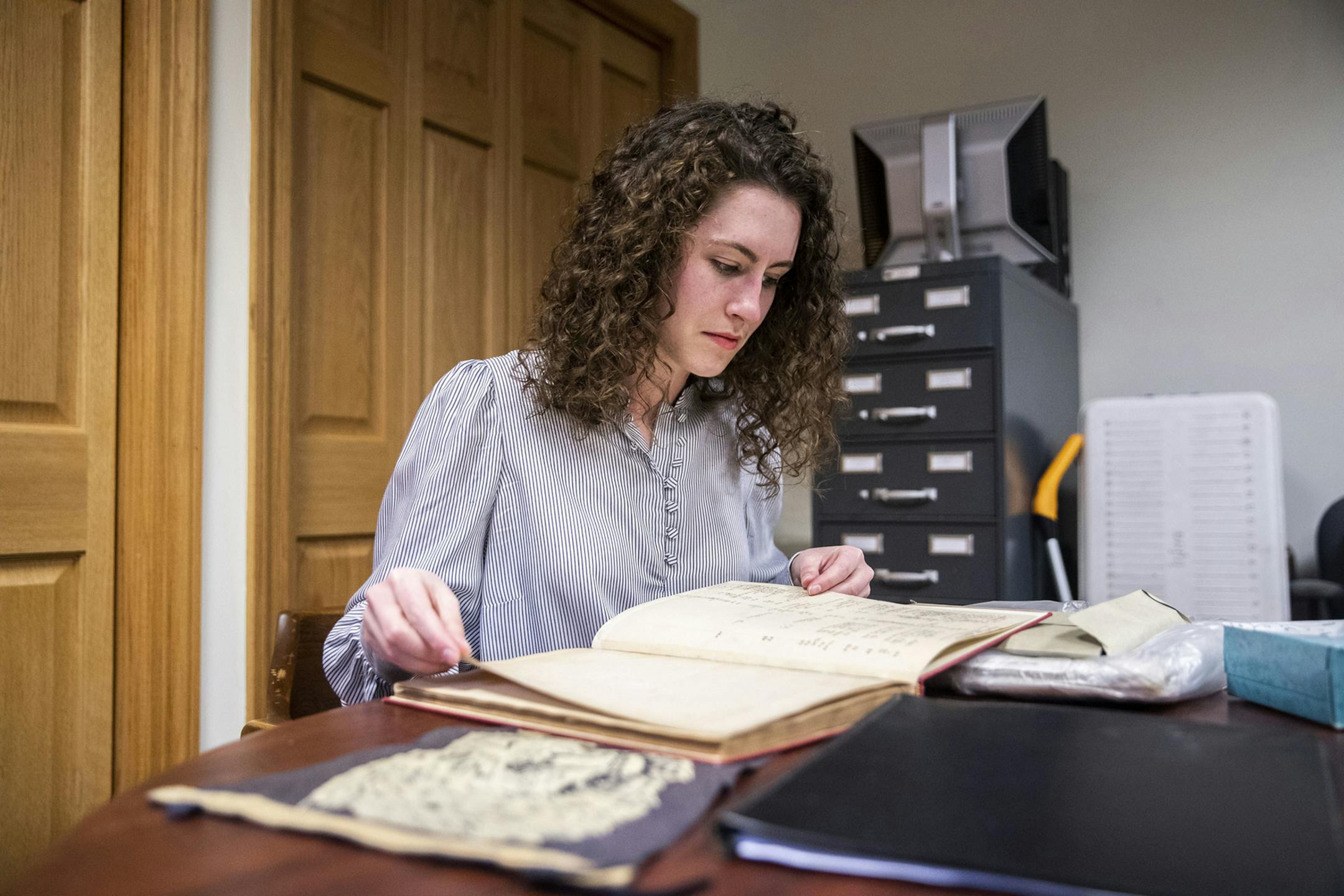 Angelina Lincoln looks at material in the archives of the St. Thomas of Villanova monastery on Tuesday, Feb. 18, 2020. Villanova graduate student Lincoln started researching the Moulden family and their ties to Villanova University in the summer of 2019. (Monica Herndon/The Philadelphia Inquirer/TNS
