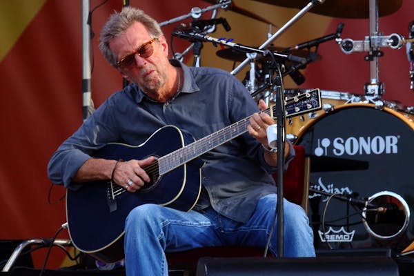 In this April 27, 2014 file photo, Eric Clapton performs at the 2014 New Orleans Jazz &amp; Heritage Festival at Fair Grounds Race Course in New Orlea