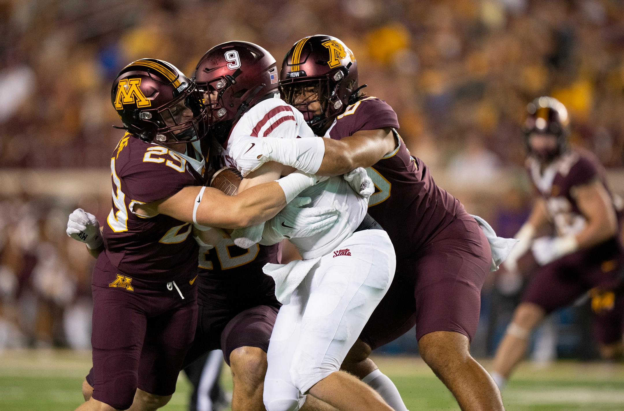 Minnesota Golden Gophers linebacker Josh Aune (29) and Minnesota Golden Gophers defensive lineman Anthony Smith (80) smothered New Mexico State Aggies quarterback Gavin Frakes (9) in the fourth quarter.