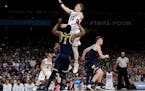 Villanova guard Donte DiVincenzo drives to the basket over Michigan guard Charles Matthews (1) during the second half in the championship game of the 